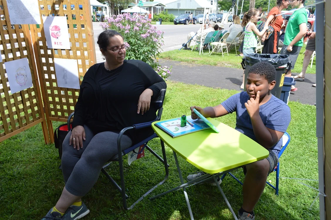 Diane Peters & Jaden in the Emerging Artists Booth