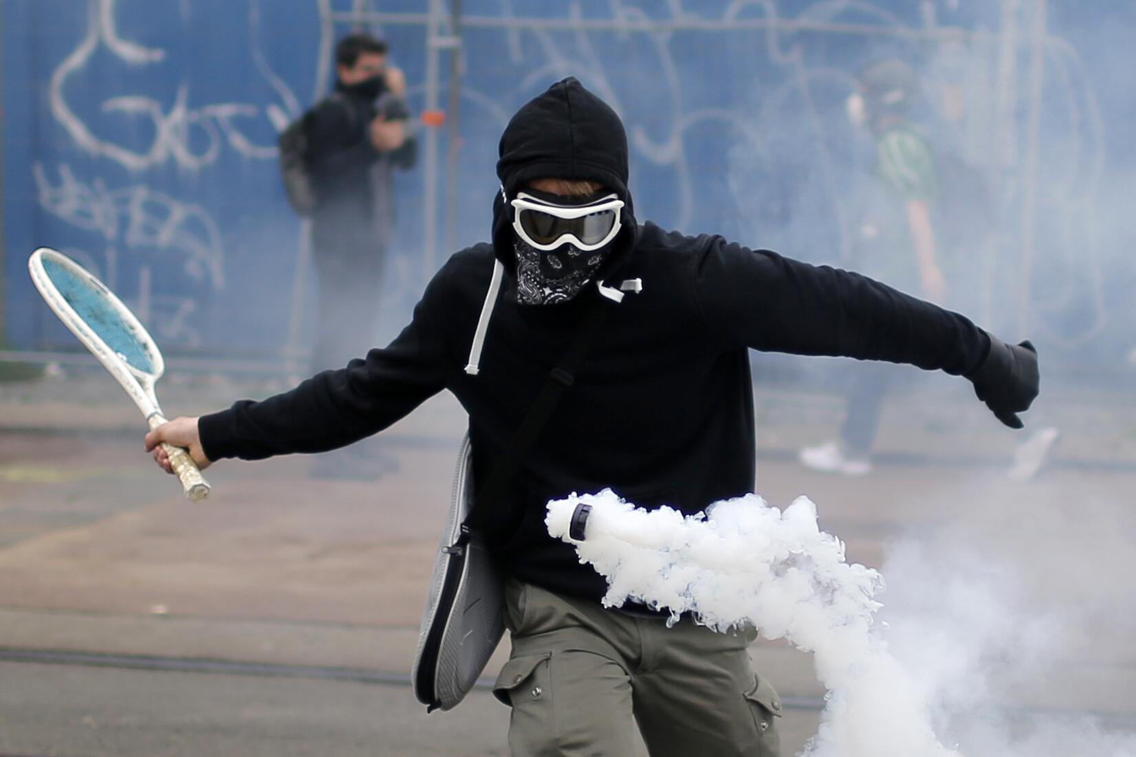 Protestor with tennis racket 