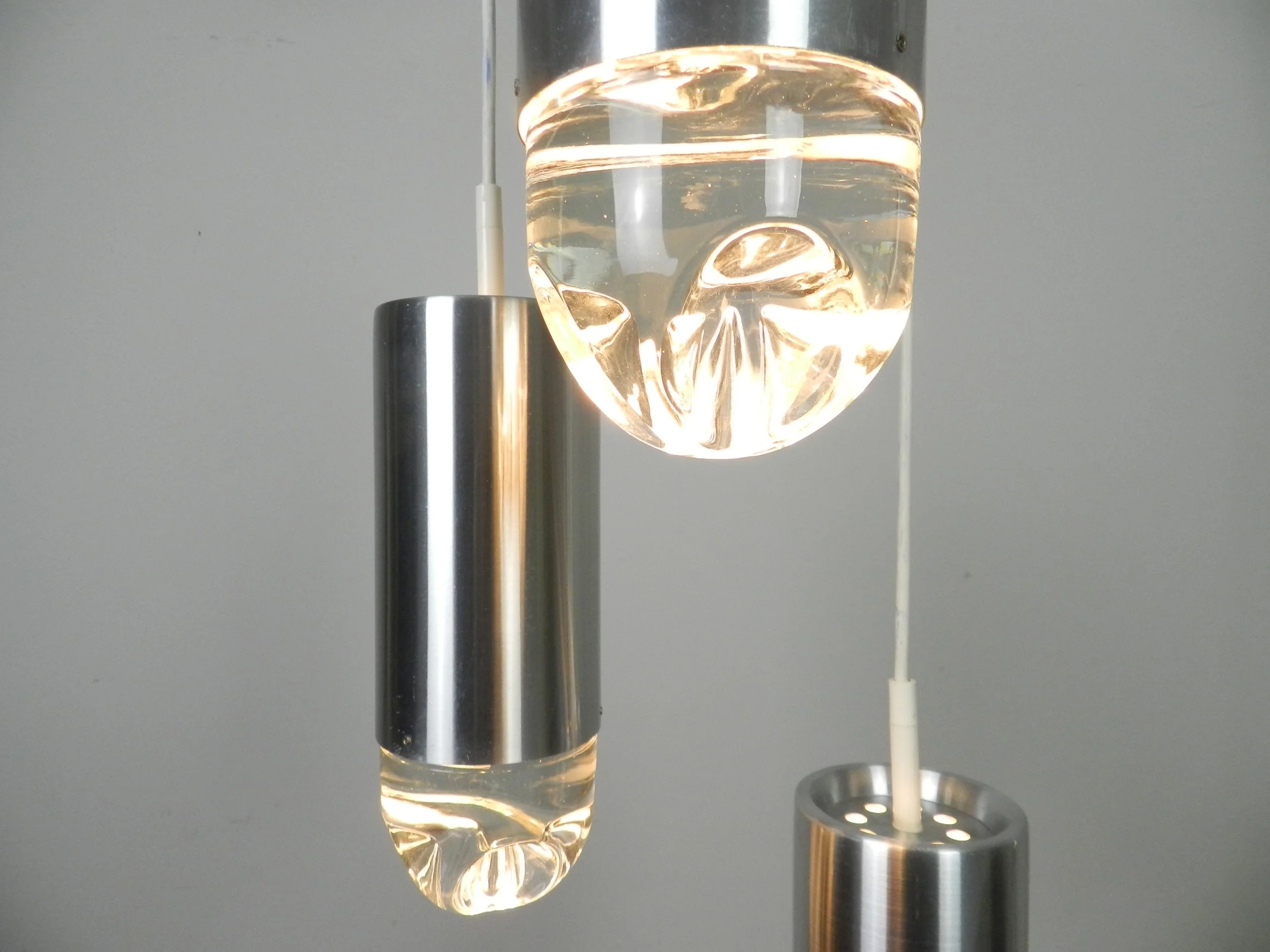 Cascade light fixture by Raak. Aluminum with heavy clear glass shades.  Netherlands, 1970s.