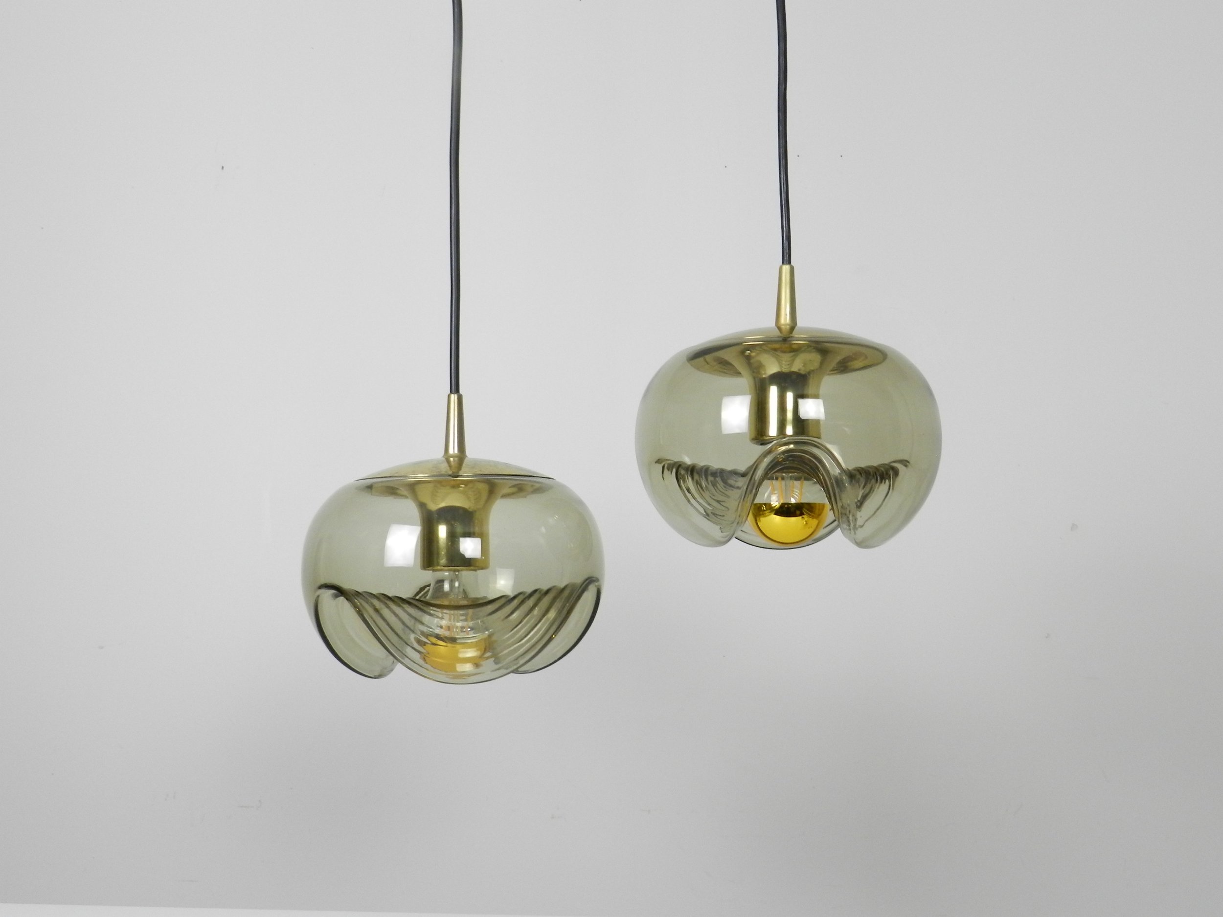 Brass and tinted glass pendant lamps by Peill and Putzler.  Germany, 1970s.