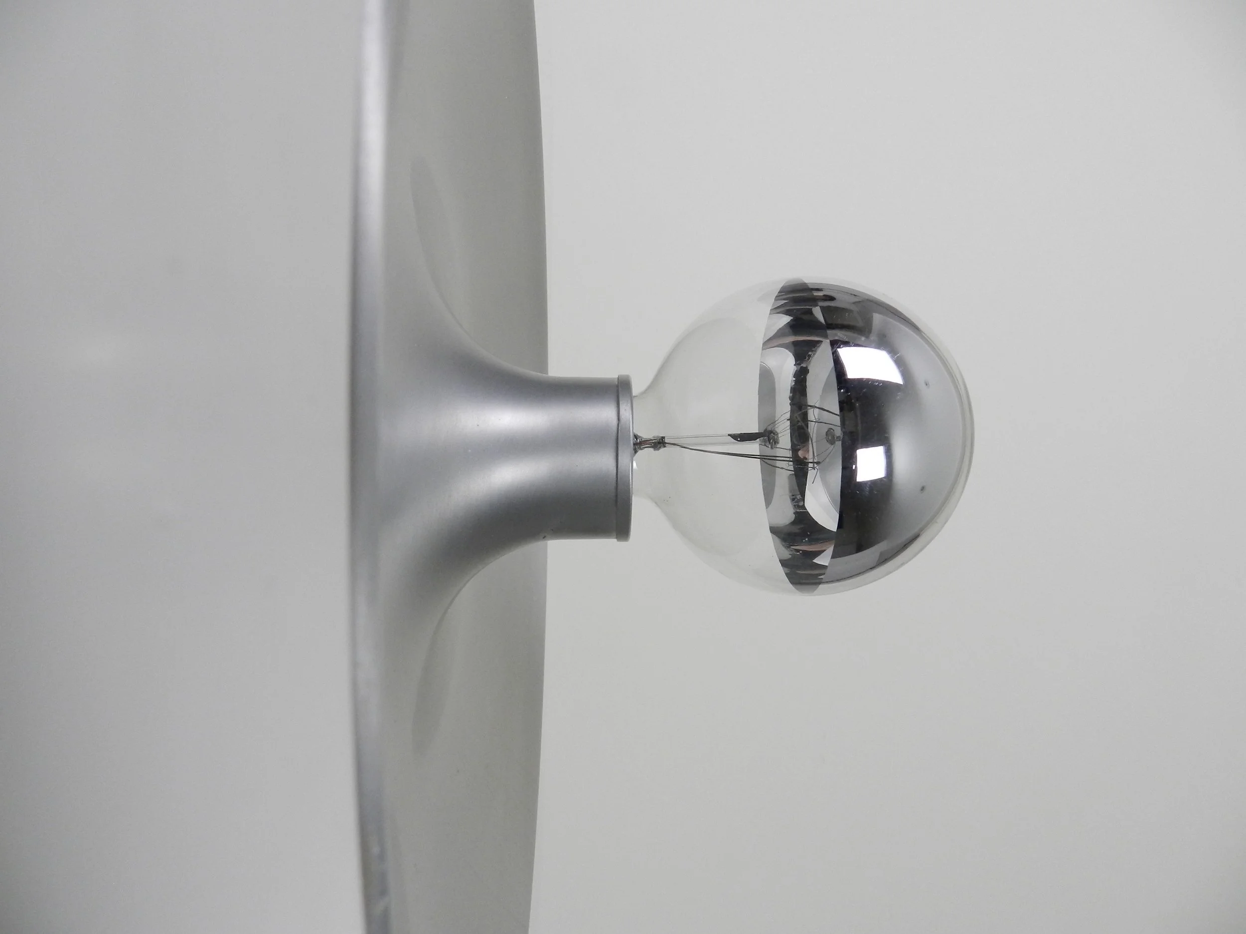 Large space age wall lamp in aluminum with plastic frame.  Germany, 1960s.