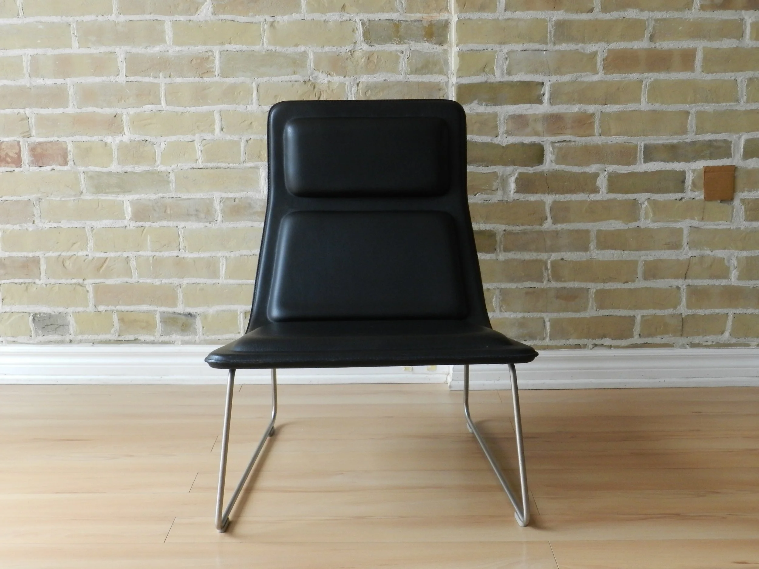 Pair of Low Pad lounge chairs designed by Jasper Morrison for Cappellini. Black leather upholstery on steel bases.  Italy, 1999.