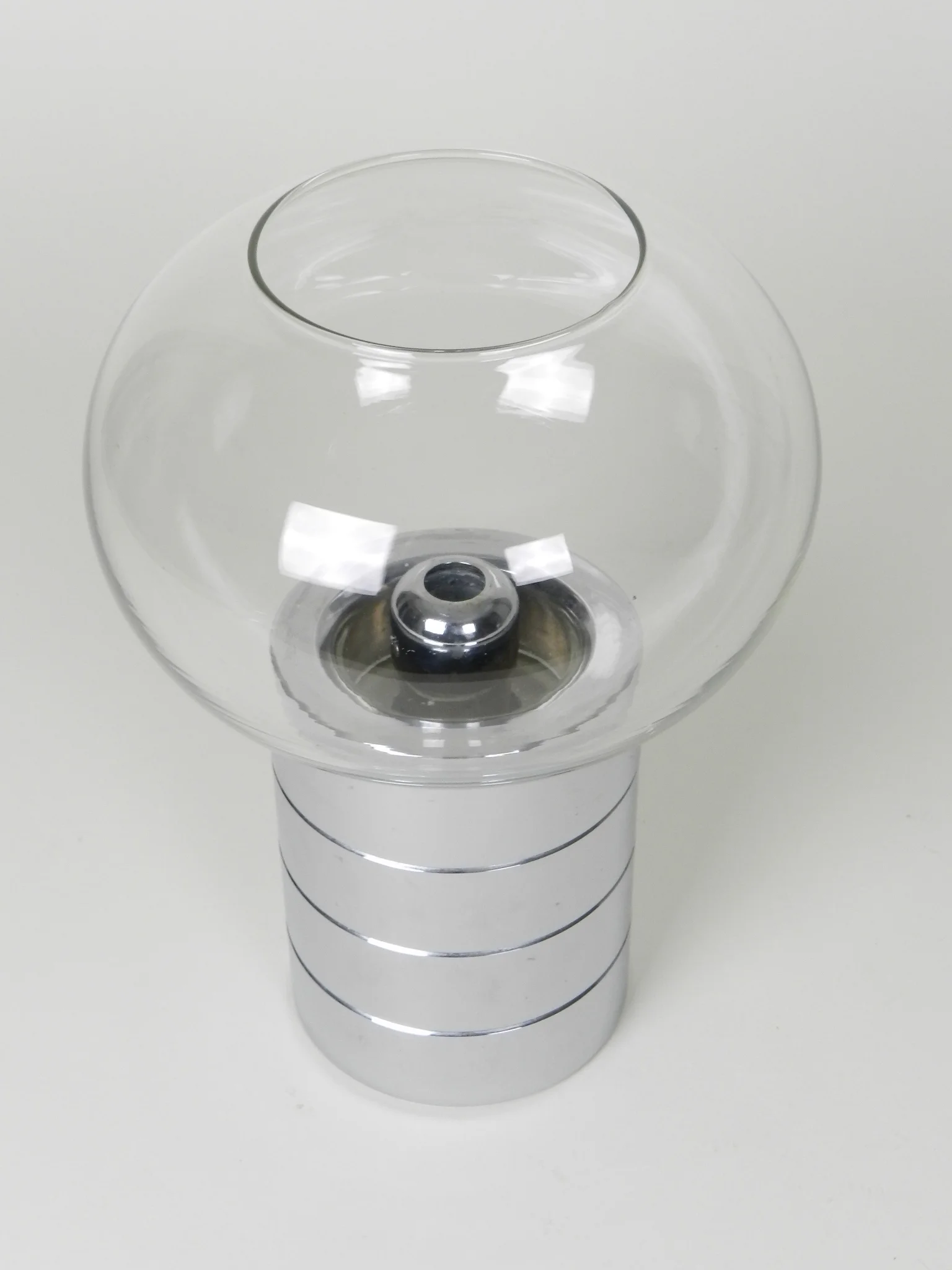 Chrome and glass spring loaded candle holder by Fohl.  Germany, 1970s.