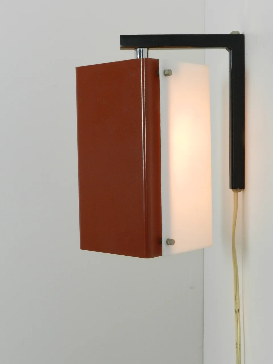 Wall lamp with pivoting shade in enameled metal and acrylic.  Netherlands, 1960s.