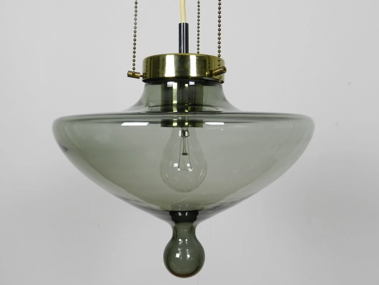 Pendant lamp by Raak. Smoked glass shade with bronze colored hardware.  Netherlands, 1960s.