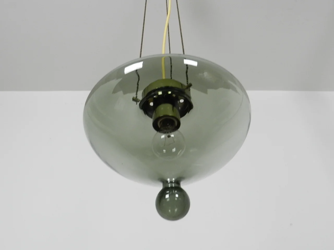 Pendant lamp by Raak. Smoked glass shade with bronze colored hardware.  Netherlands, 1960s.