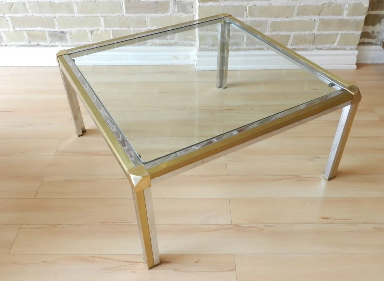 Coffee table in the style of Romeo Rega. Brass, chrome with glass top.  circa 1970s.