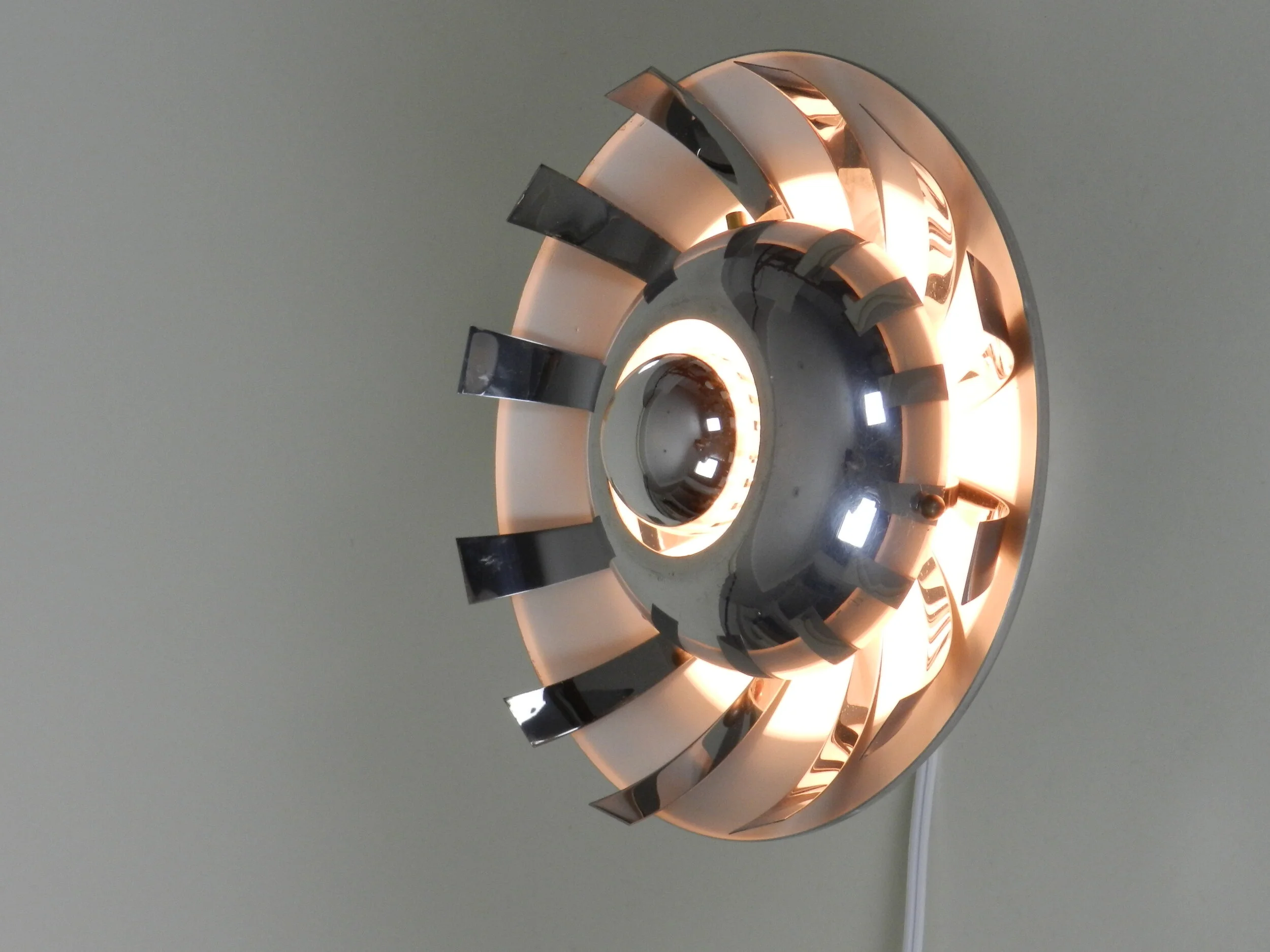 Space age wall lamp in polished aluminum.  France, 1970s.