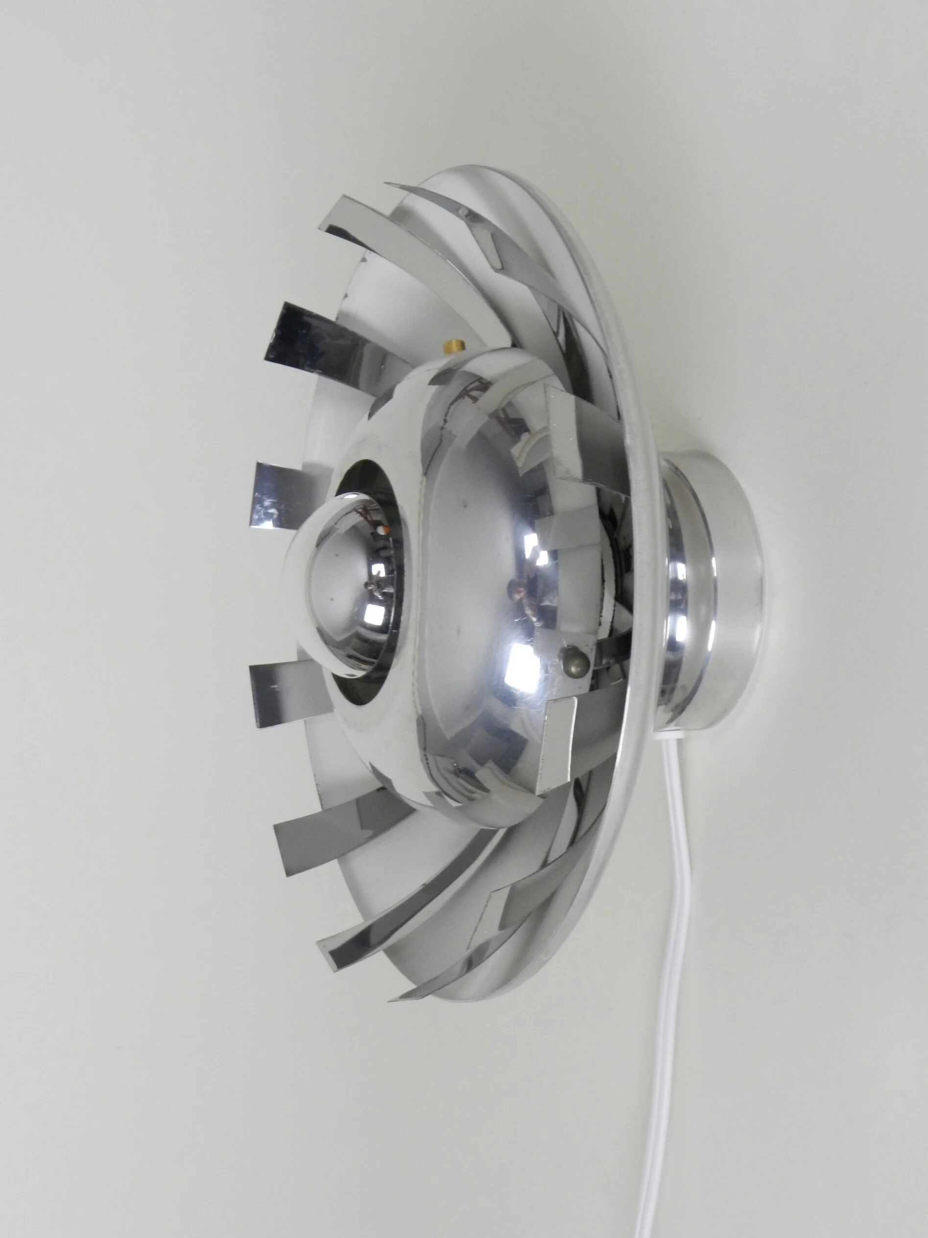 Space age wall lamp in polished aluminum.  France, 1970s.