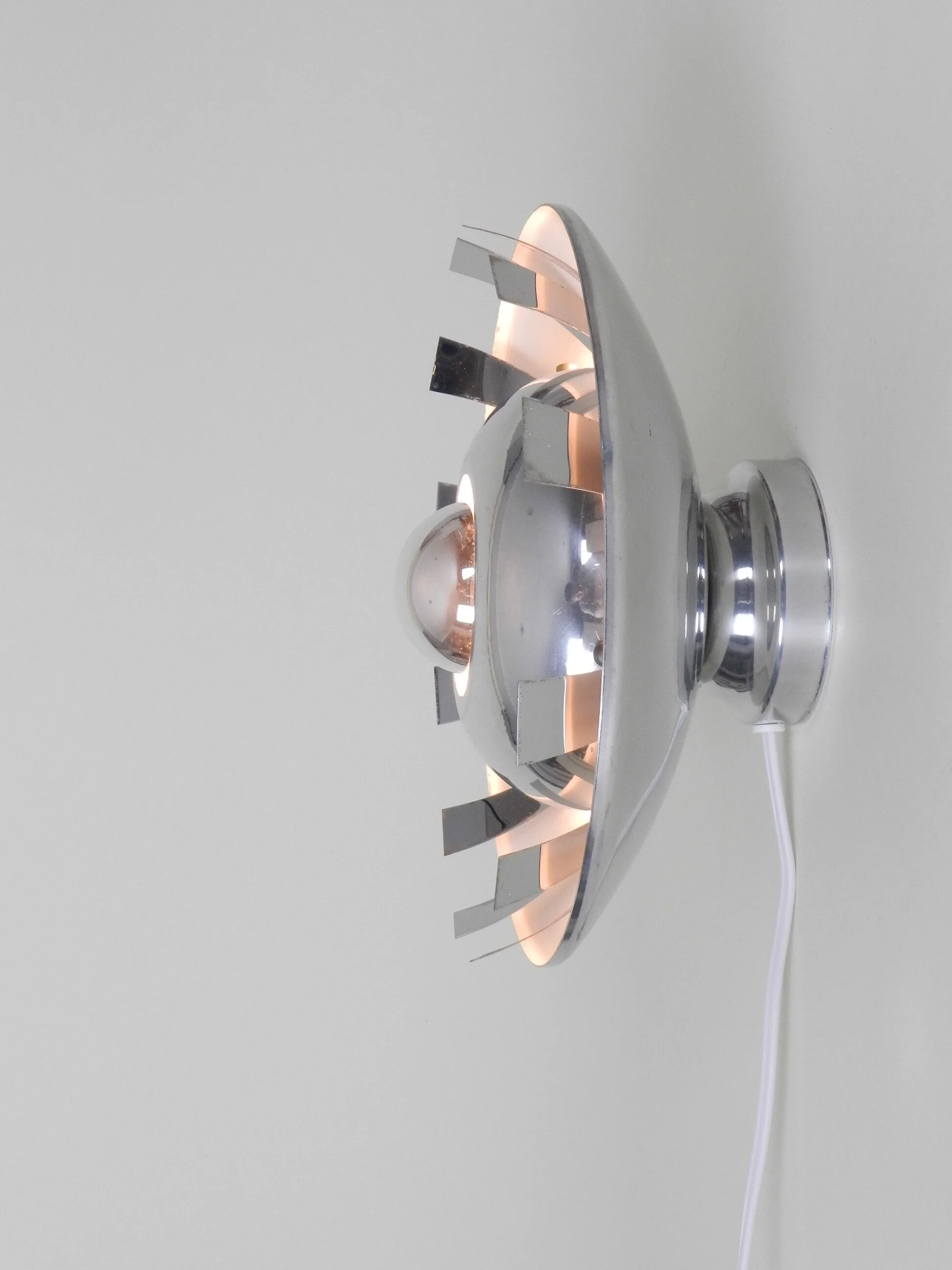 Space age wall lamp in polished aluminum.  France, 1970s.