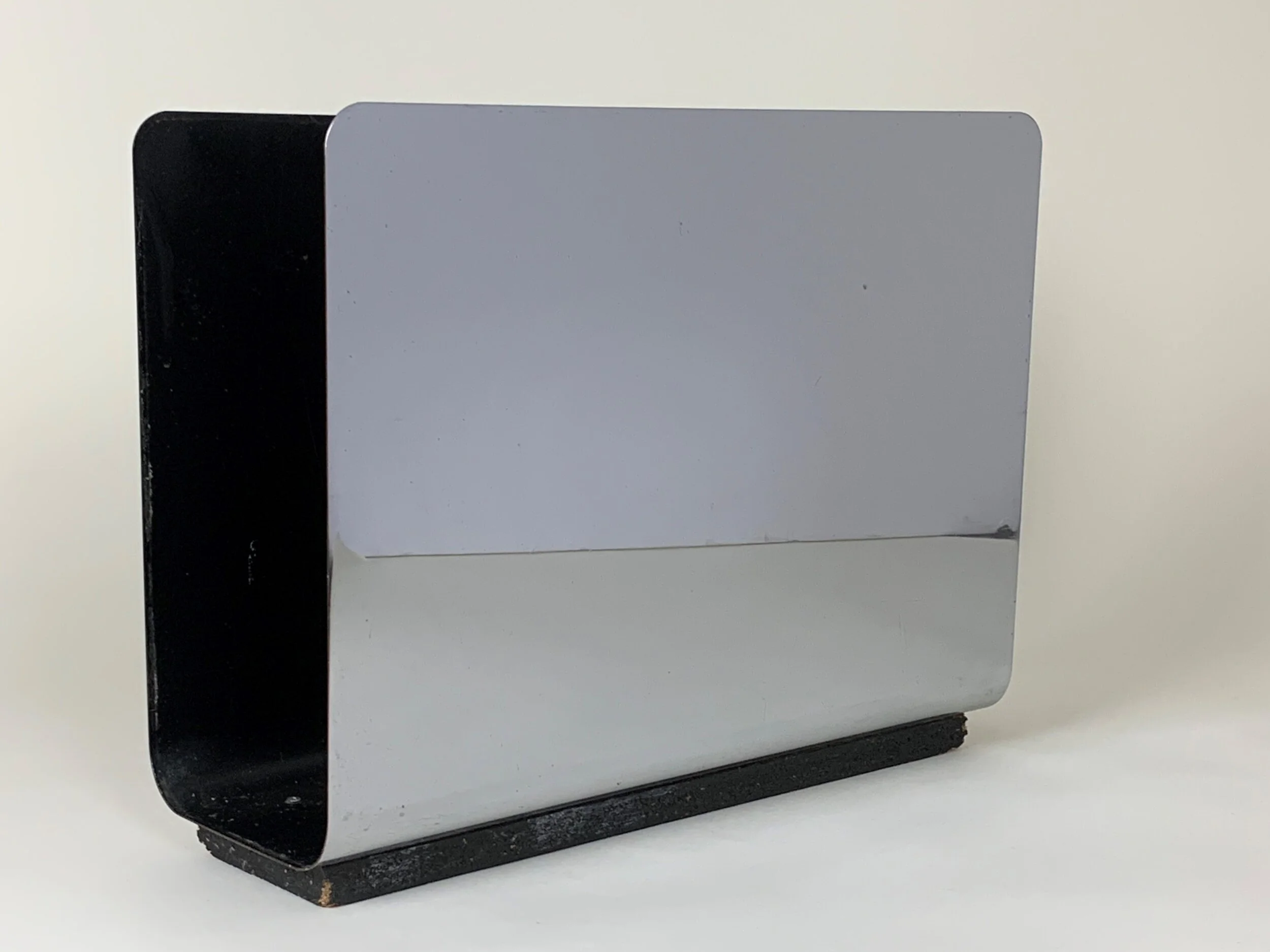Modernist magazine rack in chromed and painted steel.  circa 1970s.