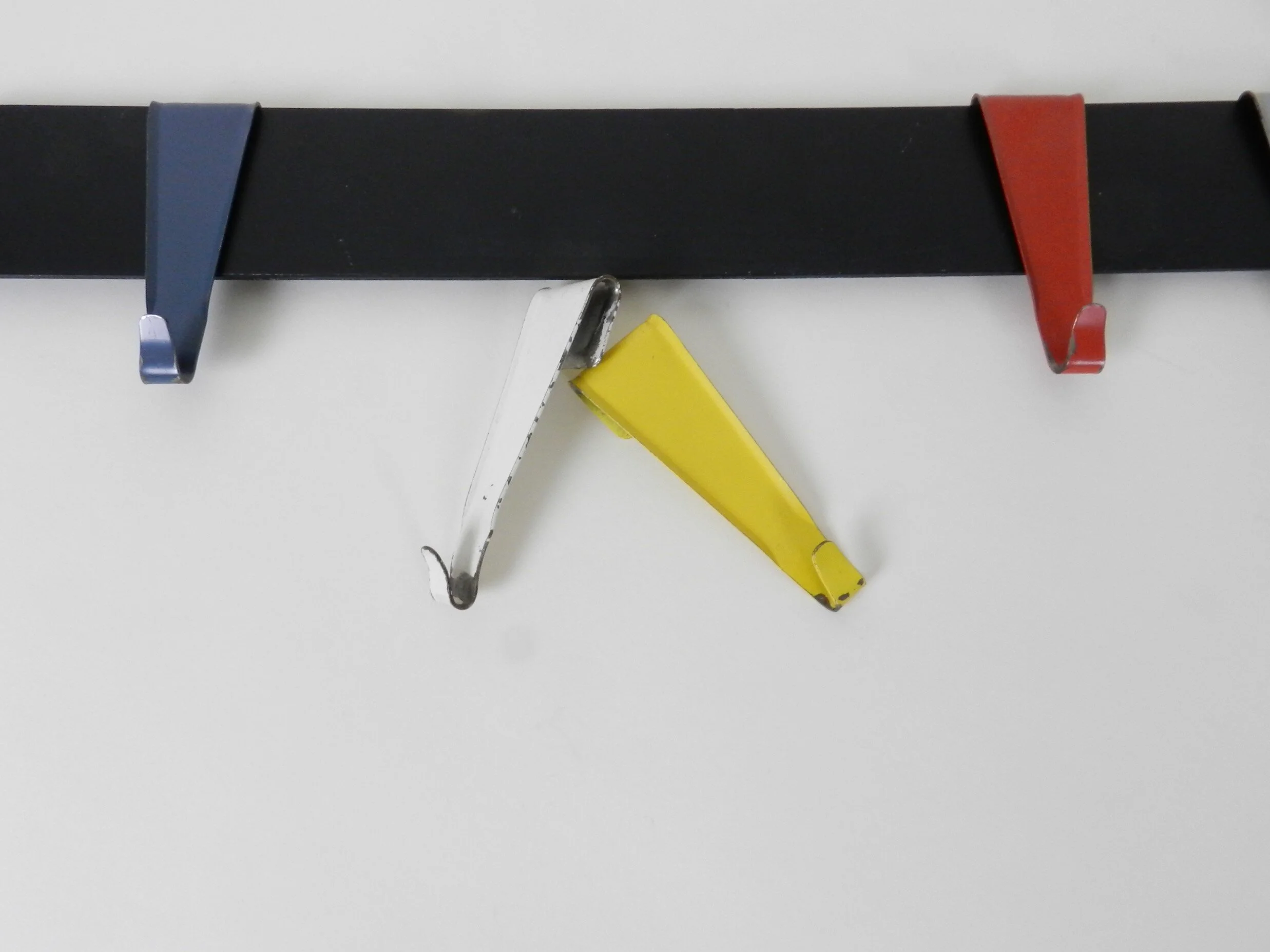 Enameled metal coat rack designed by Coen de Vries for Pilastro.  Netherlands, 1950s.