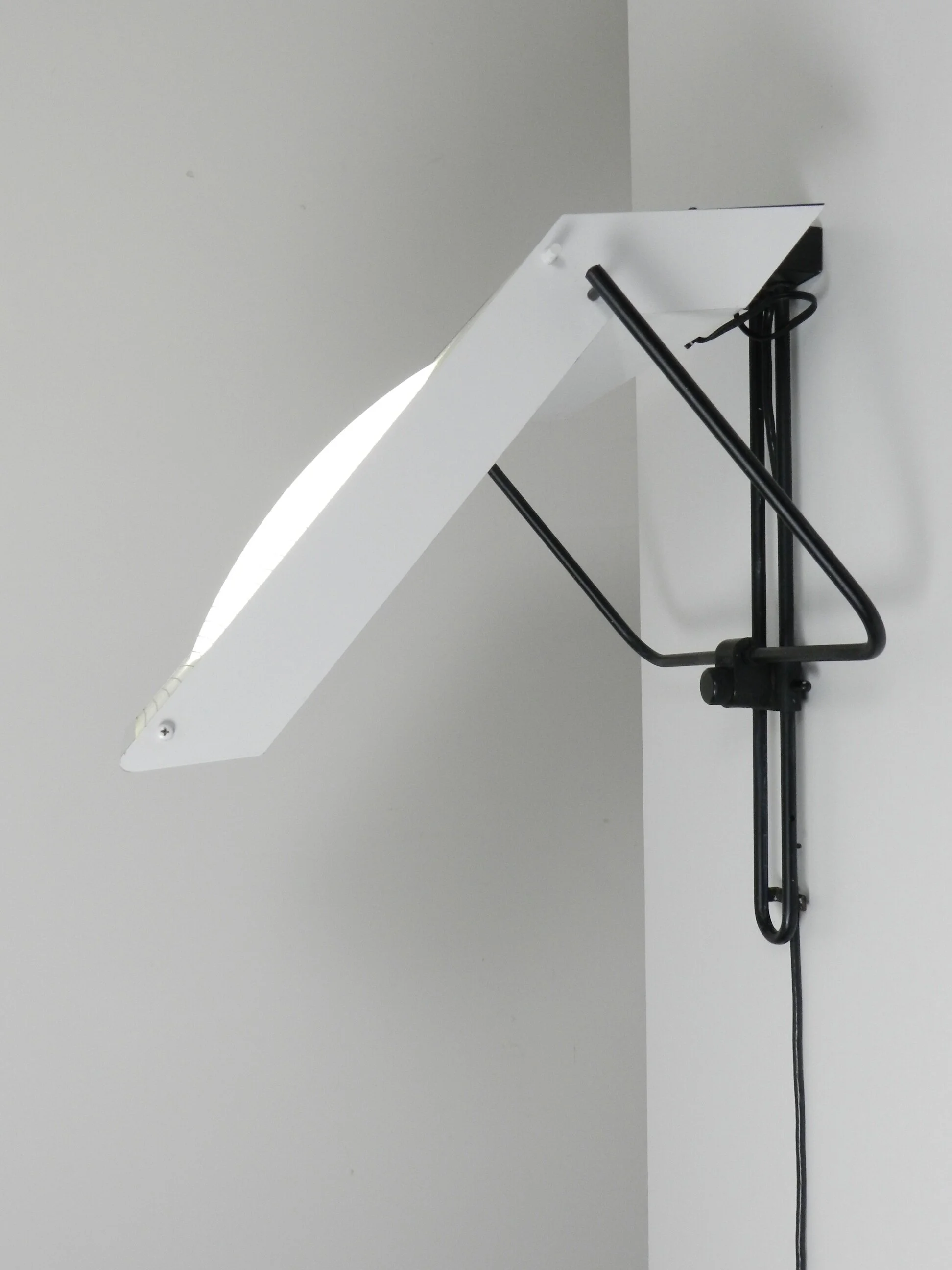 Post modern wall lamp in enameled metal with acrylic diffuser.  Created by Stilnovo.  Italy, 1980s.