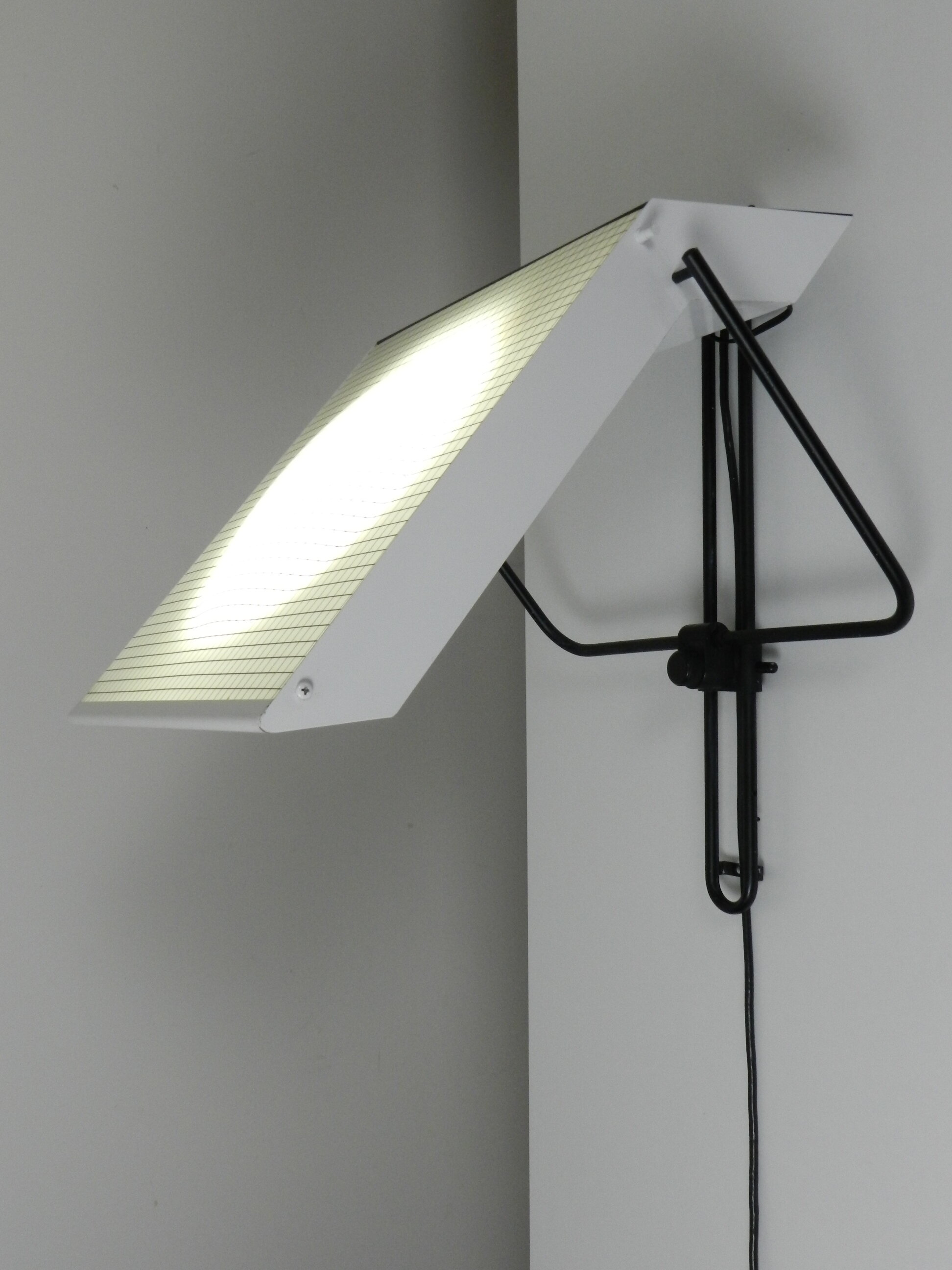 Post modern wall lamp in enameled metal with acrylic diffuser.  Created by Stilnovo.  Italy, 1980s.