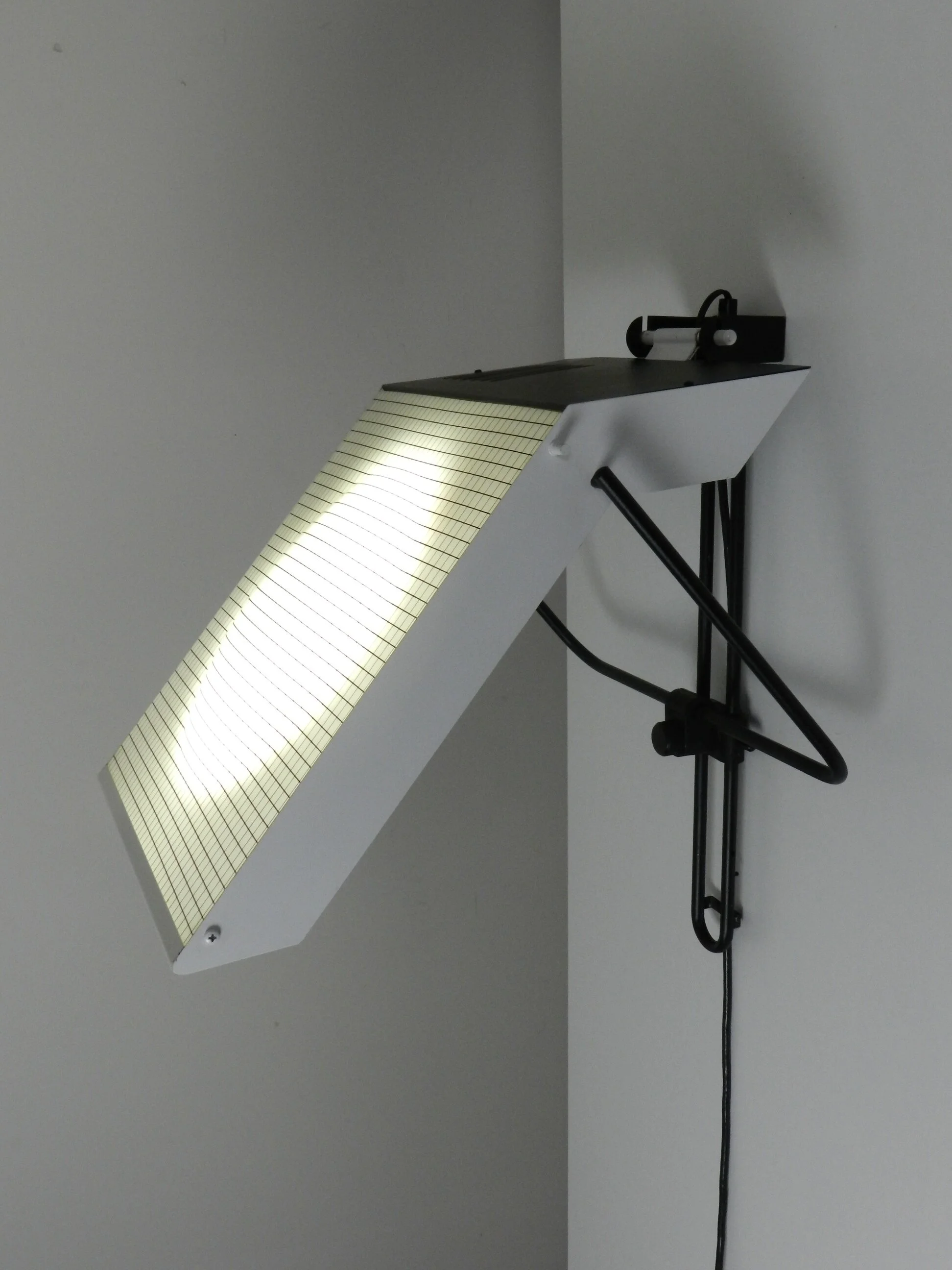 Post modern wall lamp in enameled metal with acrylic diffuser.  Created by Stilnovo.  Italy, 1980s.