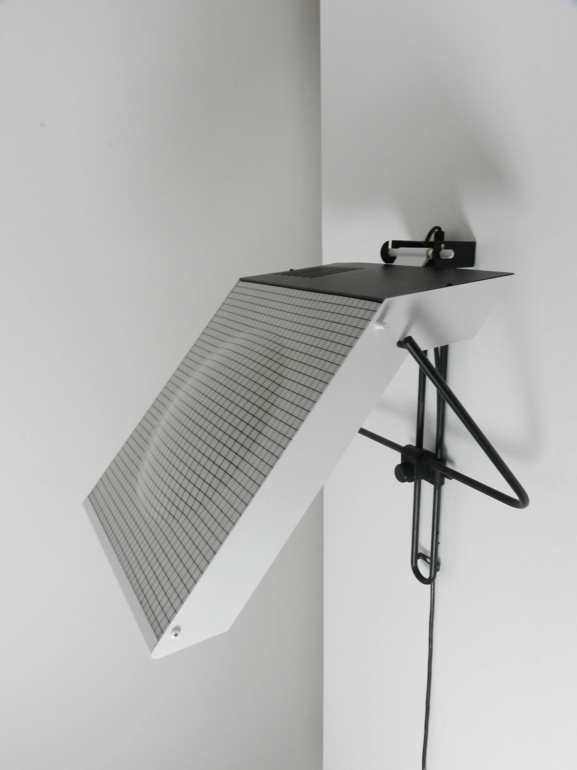 Post modern wall lamp in enameled metal with acrylic diffuser.  Created by Stilnovo.  Italy, 1980s.