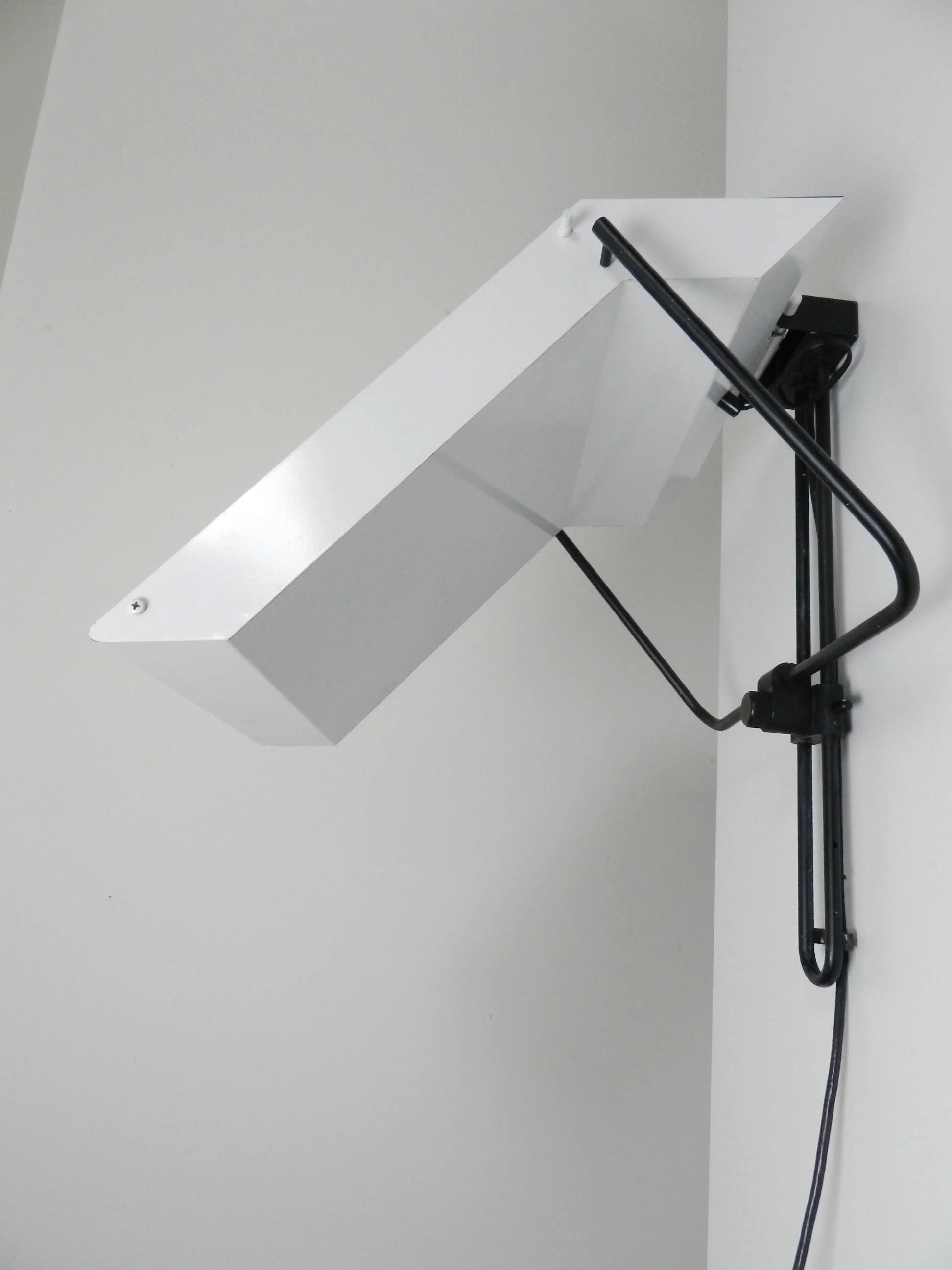 Post modern wall lamp in enameled metal with acrylic diffuser.  Created by Stilnovo.  Italy, 1980s.