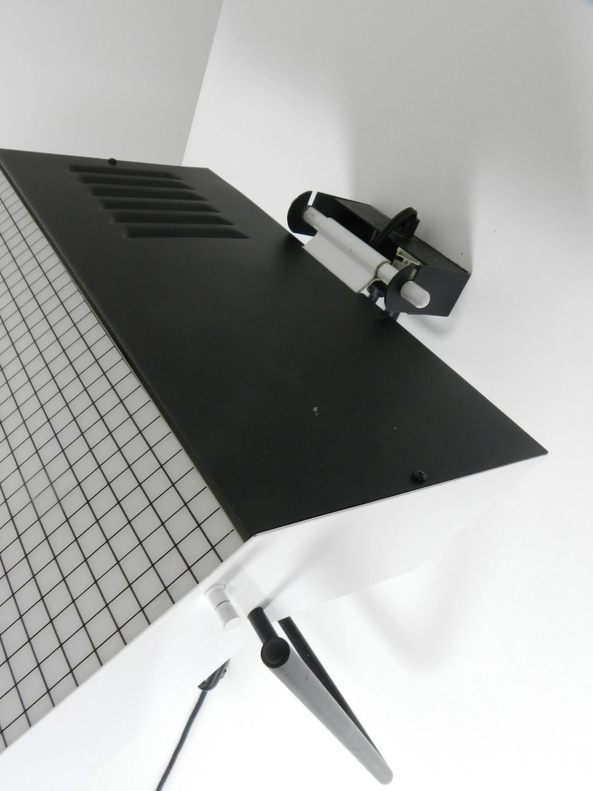 Post modern wall lamp in enameled metal with acrylic diffuser.  Created by Stilnovo.  Italy, 1980s.