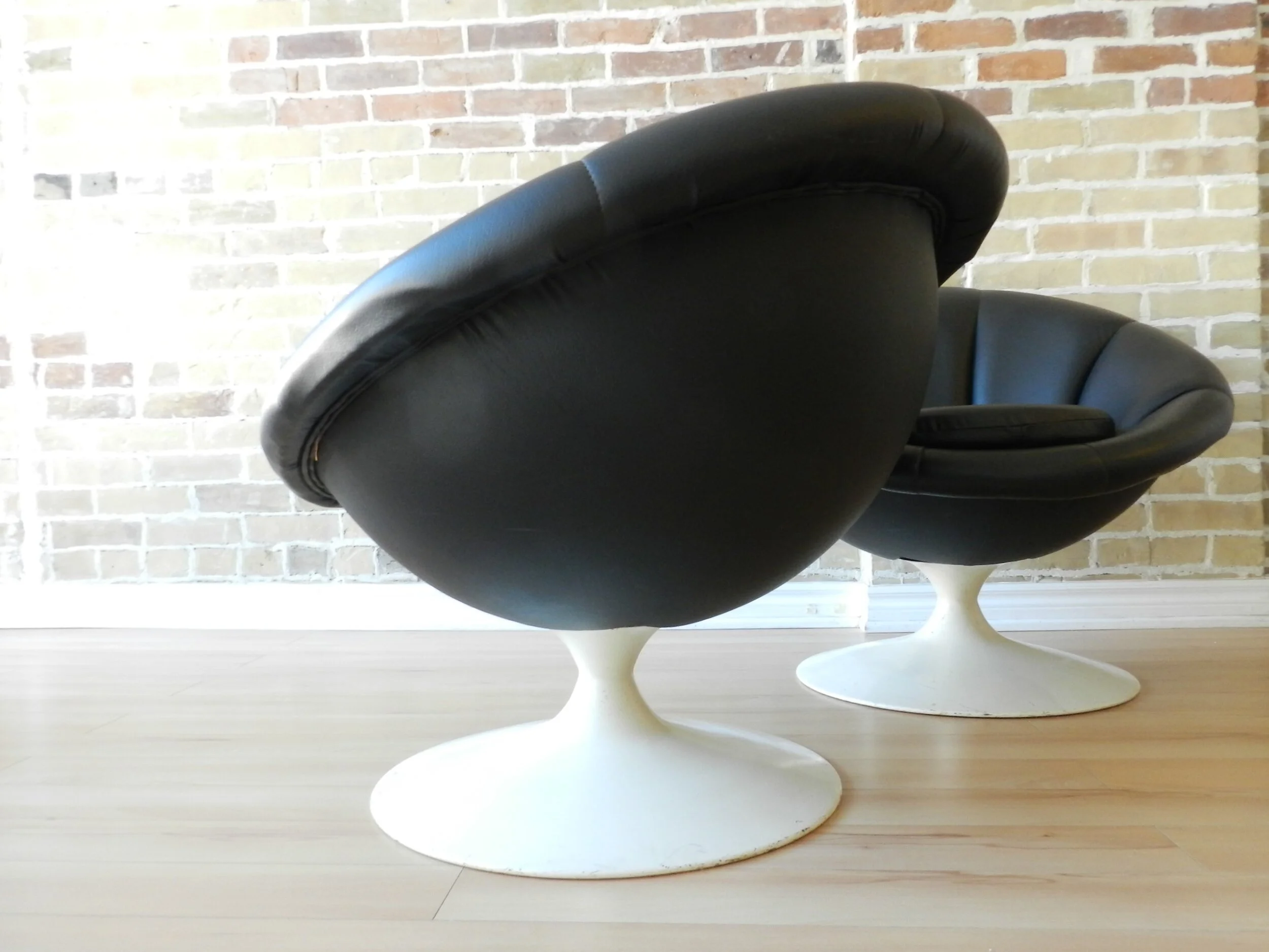 Pair of space age lounge chairs with black vinyl upholstery. Part of the Hystron Collection by Singer.  Canada, 1970s.