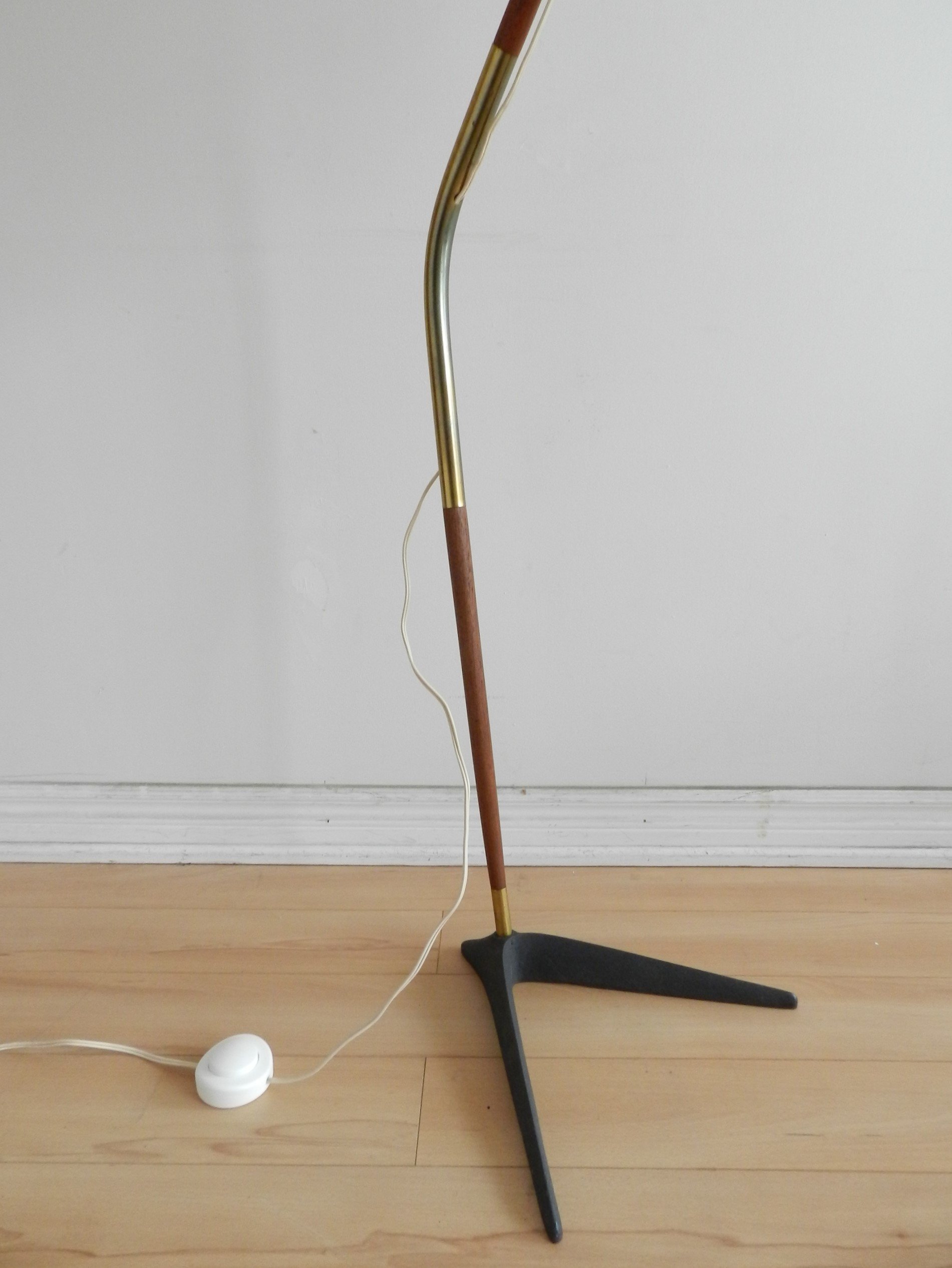 Fishing pole floor lamp in teak and brass with cast metal base and pleated shade. Designed by Svend Aage Holm Sorensen.  Denmark, 1960s.