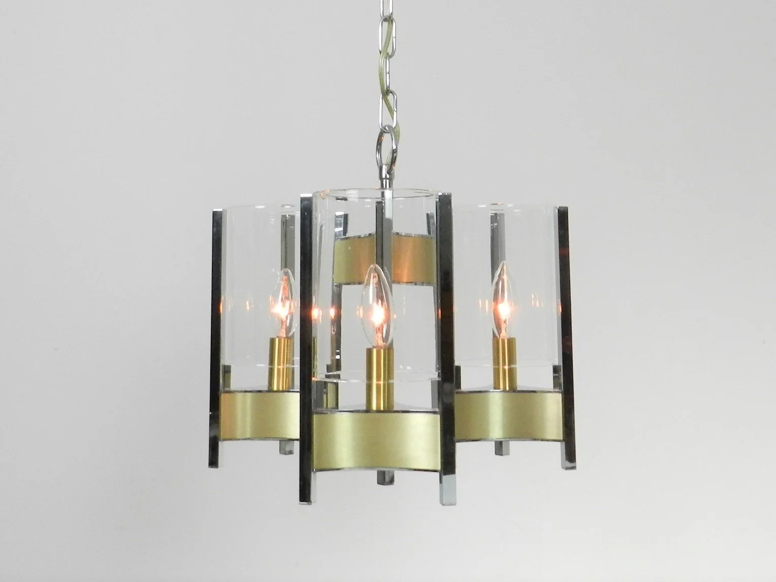 Chrome and brass chandelier with glass shades designed by Gaetano Sciolari.  Italy, 1970s.