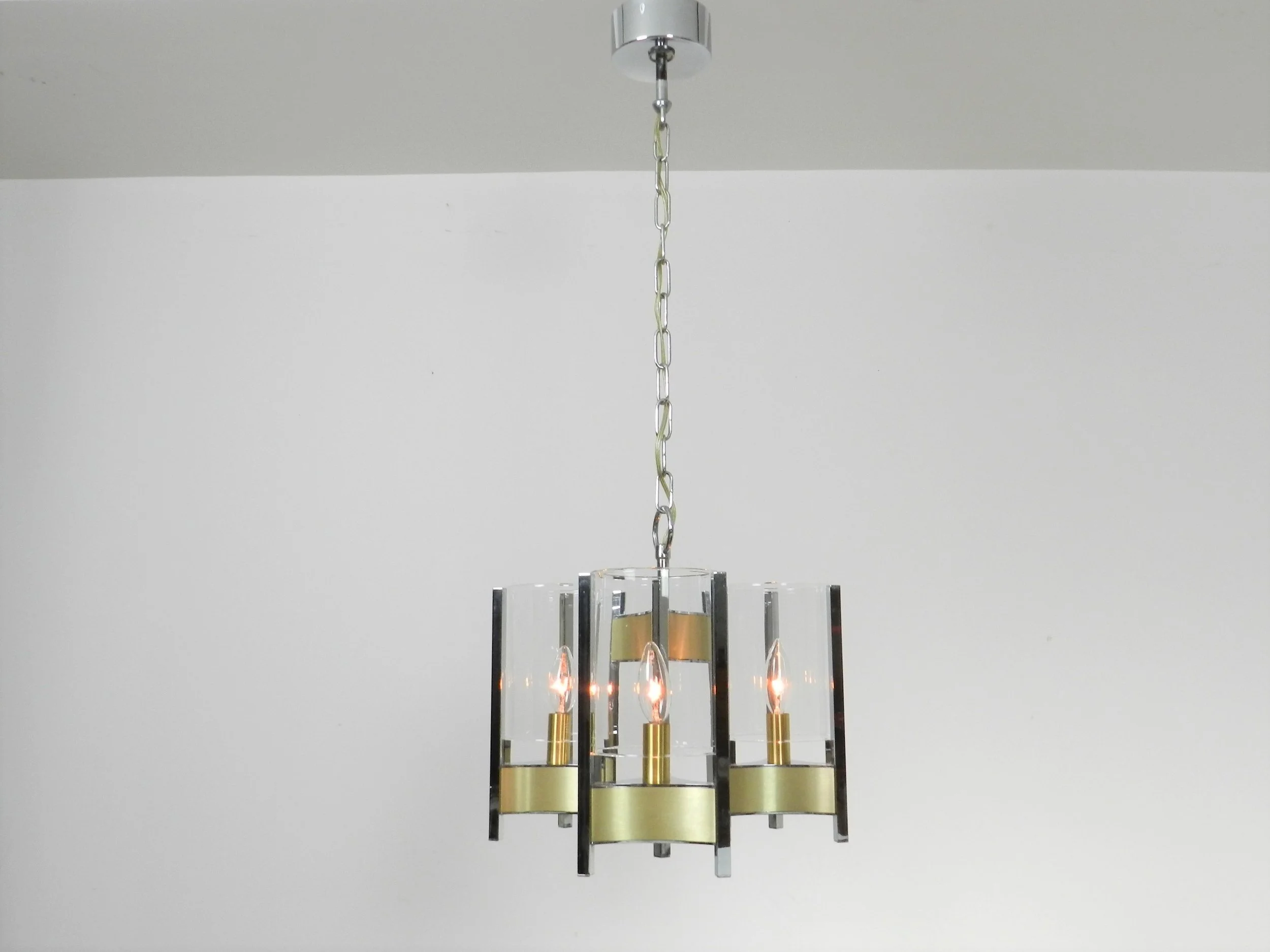Chrome and brass chandelier with glass shades designed by Gaetano Sciolari.  Italy, 1970s.