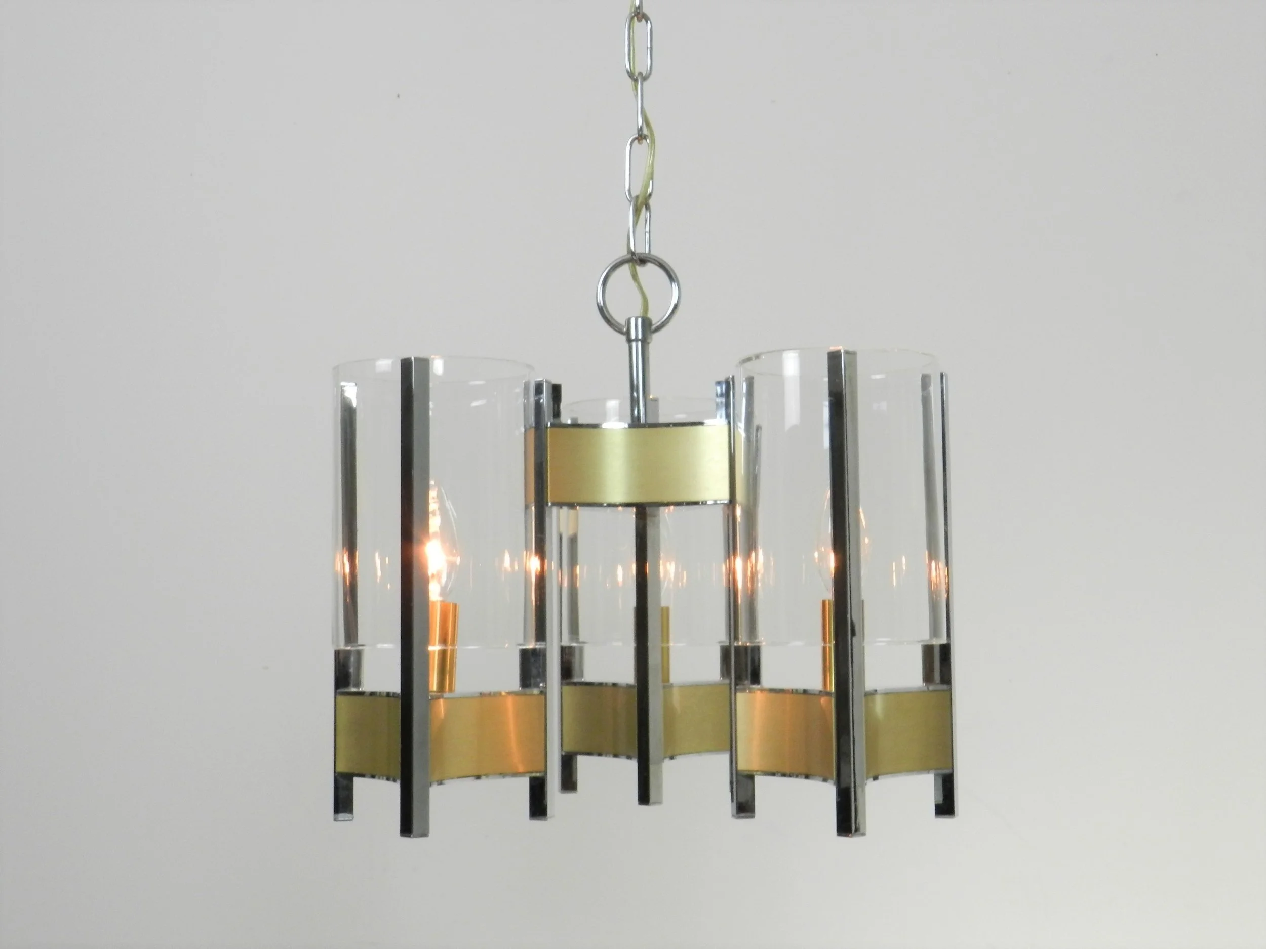 Chrome and brass chandelier with glass shades designed by Gaetano Sciolari.  Italy, 1970s.