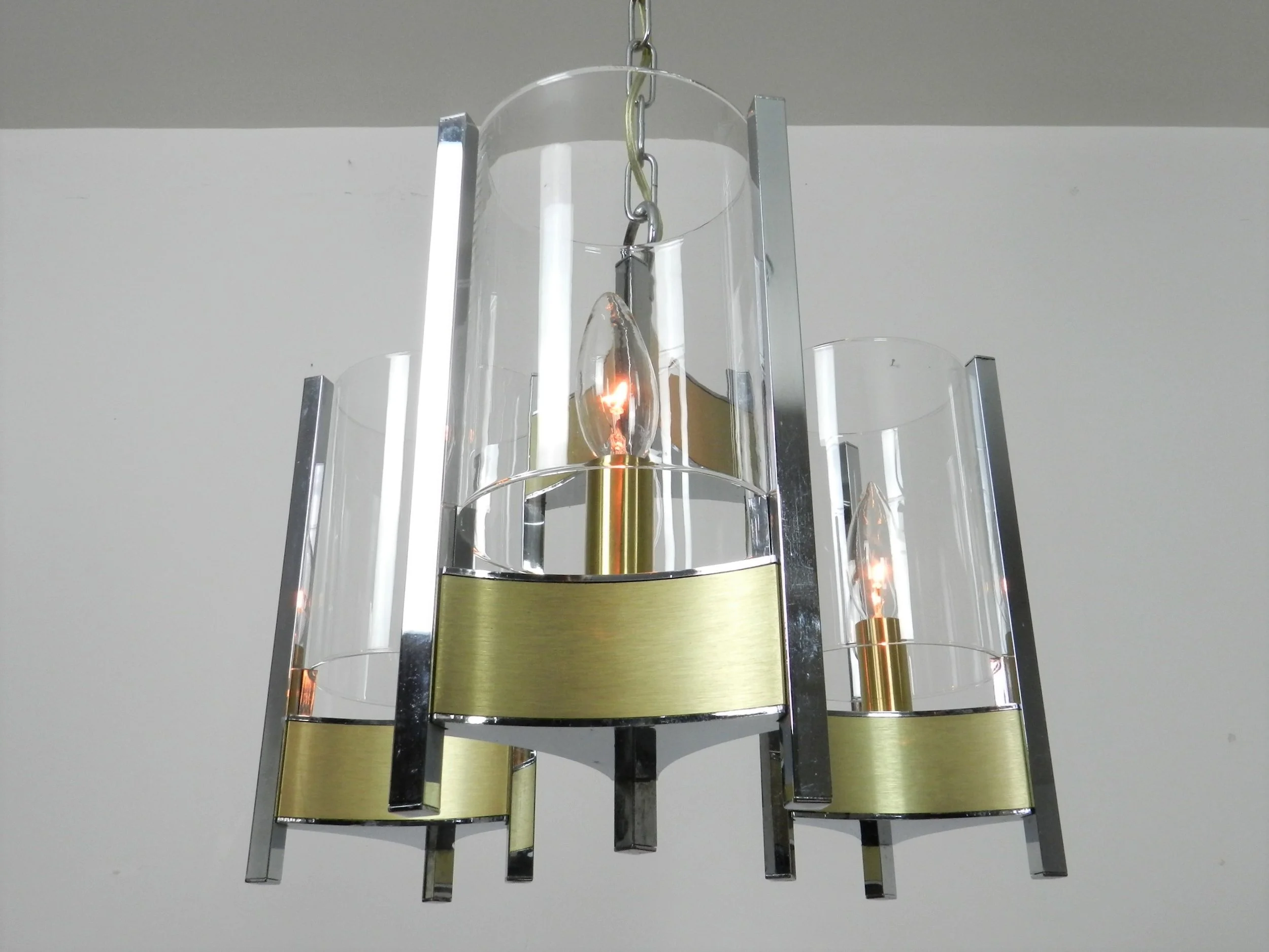 Chrome and brass chandelier with glass shades designed by Gaetano Sciolari.  Italy, 1970s.