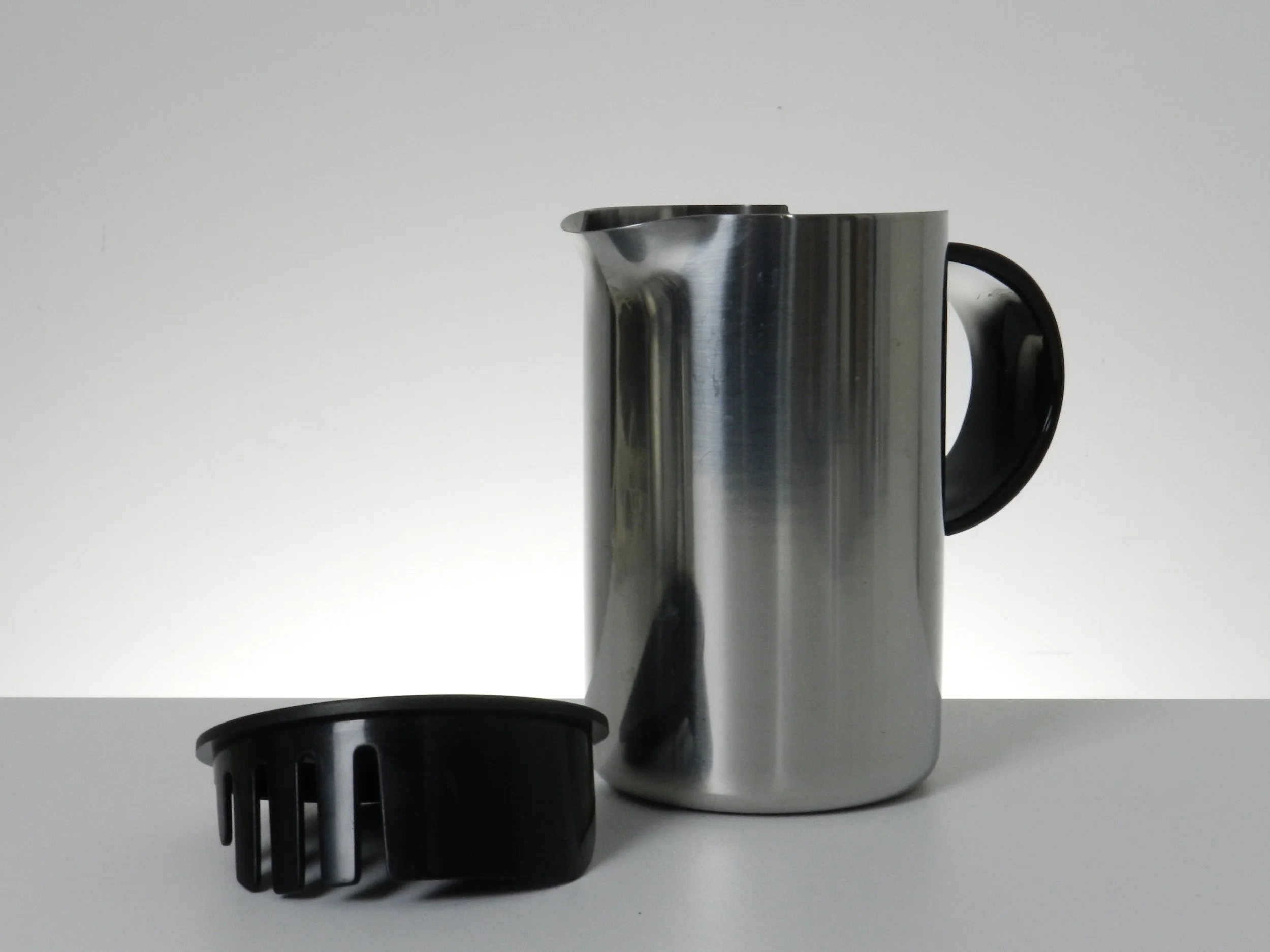 Stainless steel pitcher with plastic lid and handle designed by Erik Magnussen for Stelton.  Denmark, 1970s.