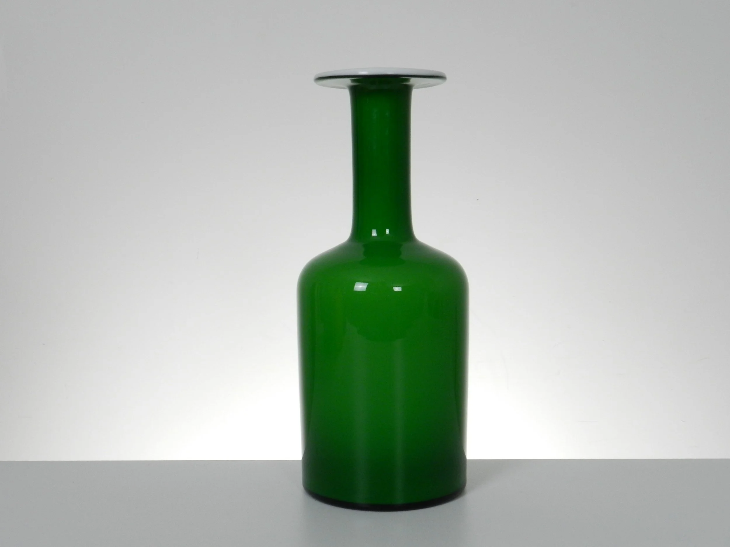 Green cased glass Gulvase designed by Otto Brauer for Holmegaard.  Denmark, 1960s.  11.75” high x 4.5” diameter.