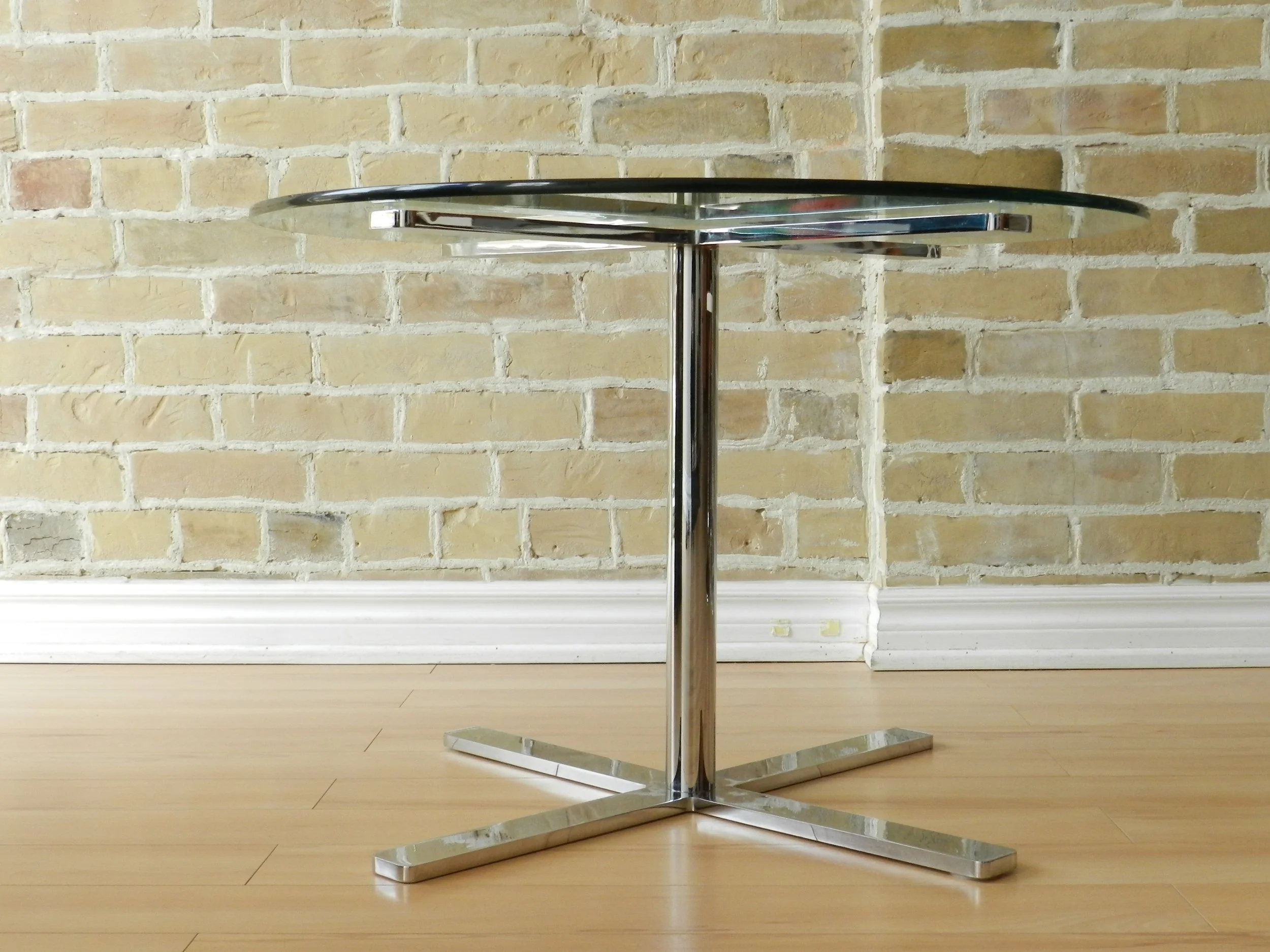 Modernist side table in solid chromed steel and glass top by Bonaventure.  Canada, 1970s.