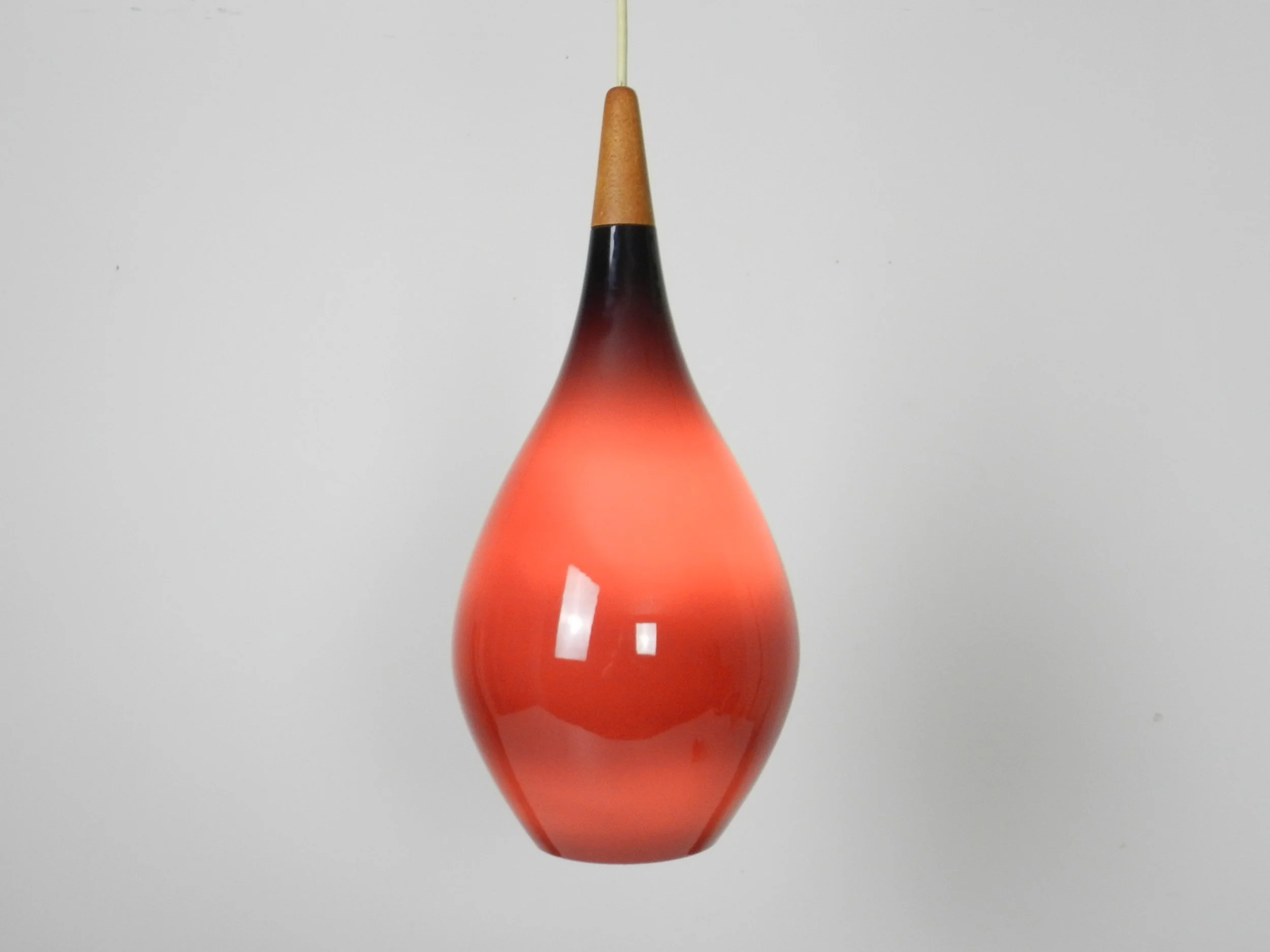 Cased glass pendant lamp with teak finial by Holmegaard.  Denmark, 1960s.