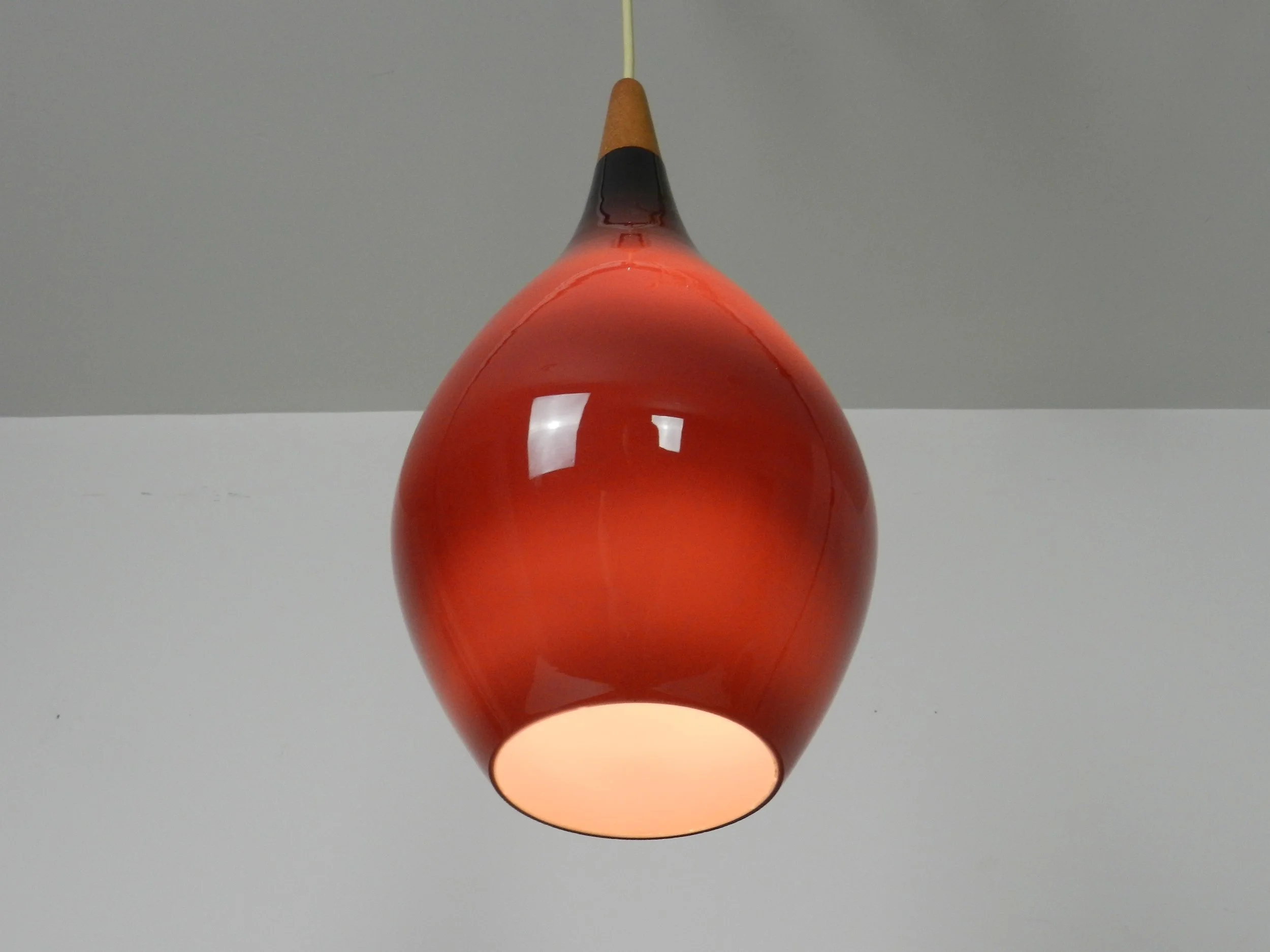 Cased glass pendant lamp with teak finial by Holmegaard.  Denmark, 1960s.