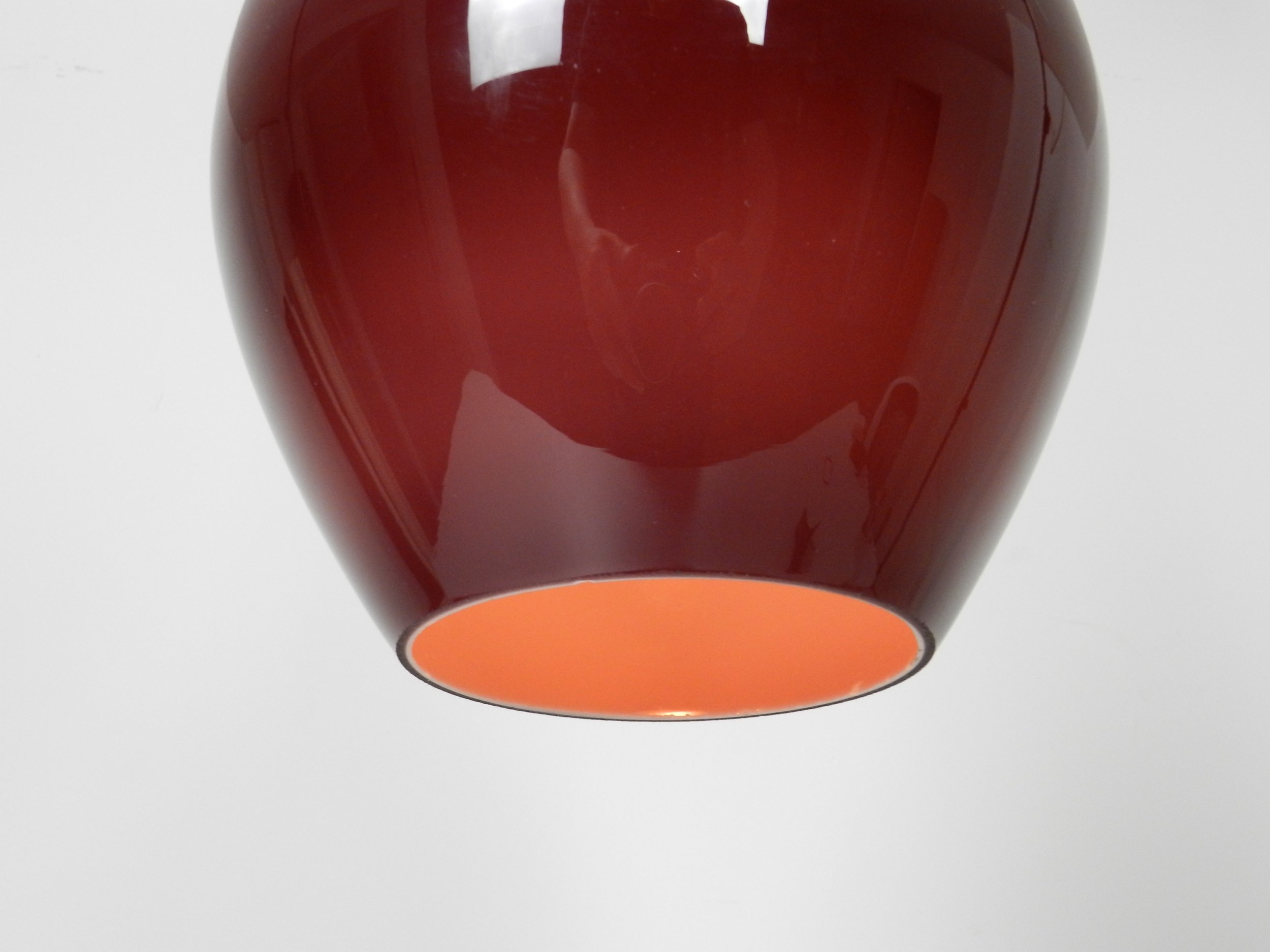 Cased glass pendant lamp with teak finial by Holmegaard.  Denmark, 1960s.