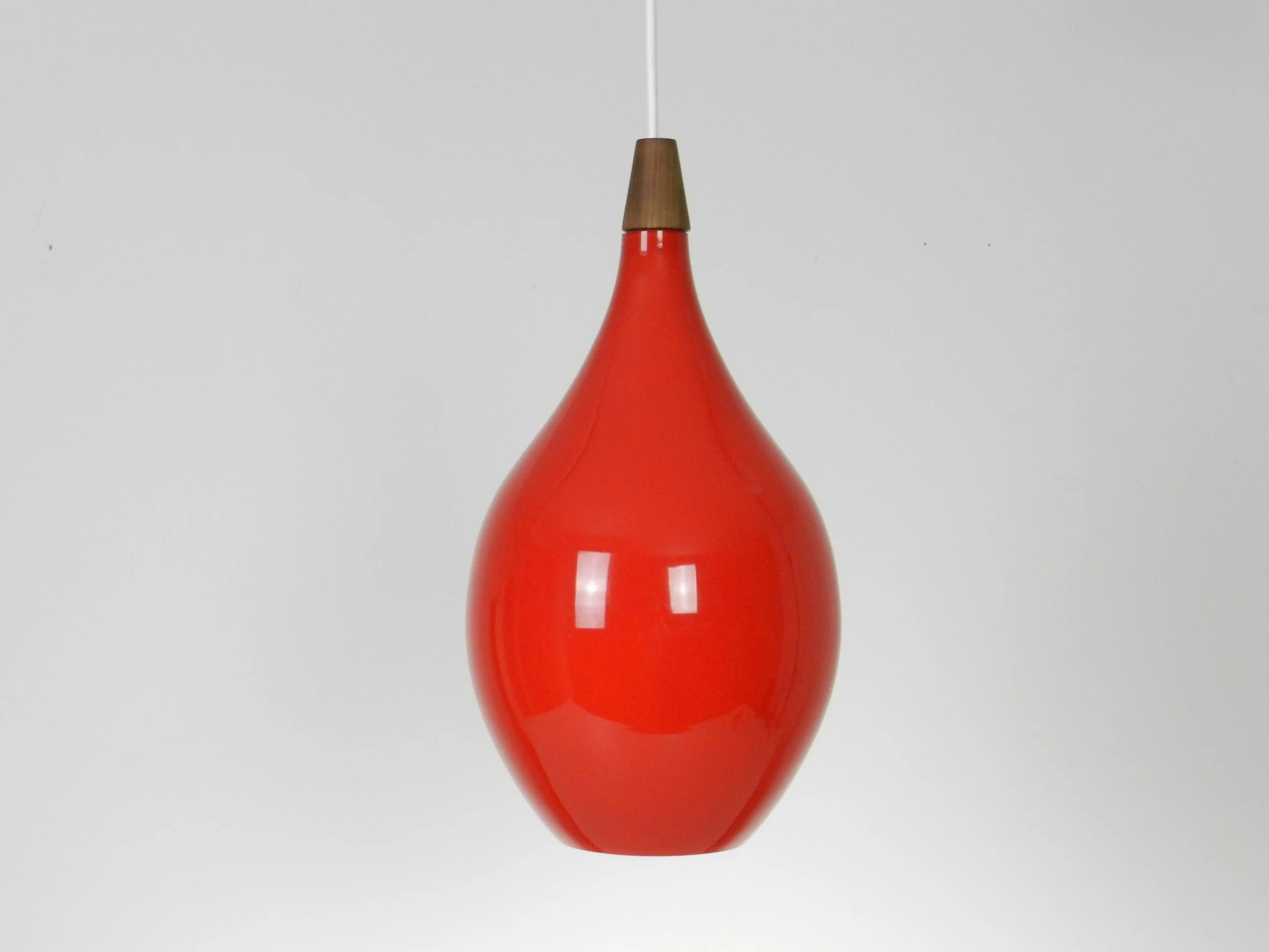 Red cased glass pendant lamp with teak finial by Holmegaard.  Denmark, 1960s.