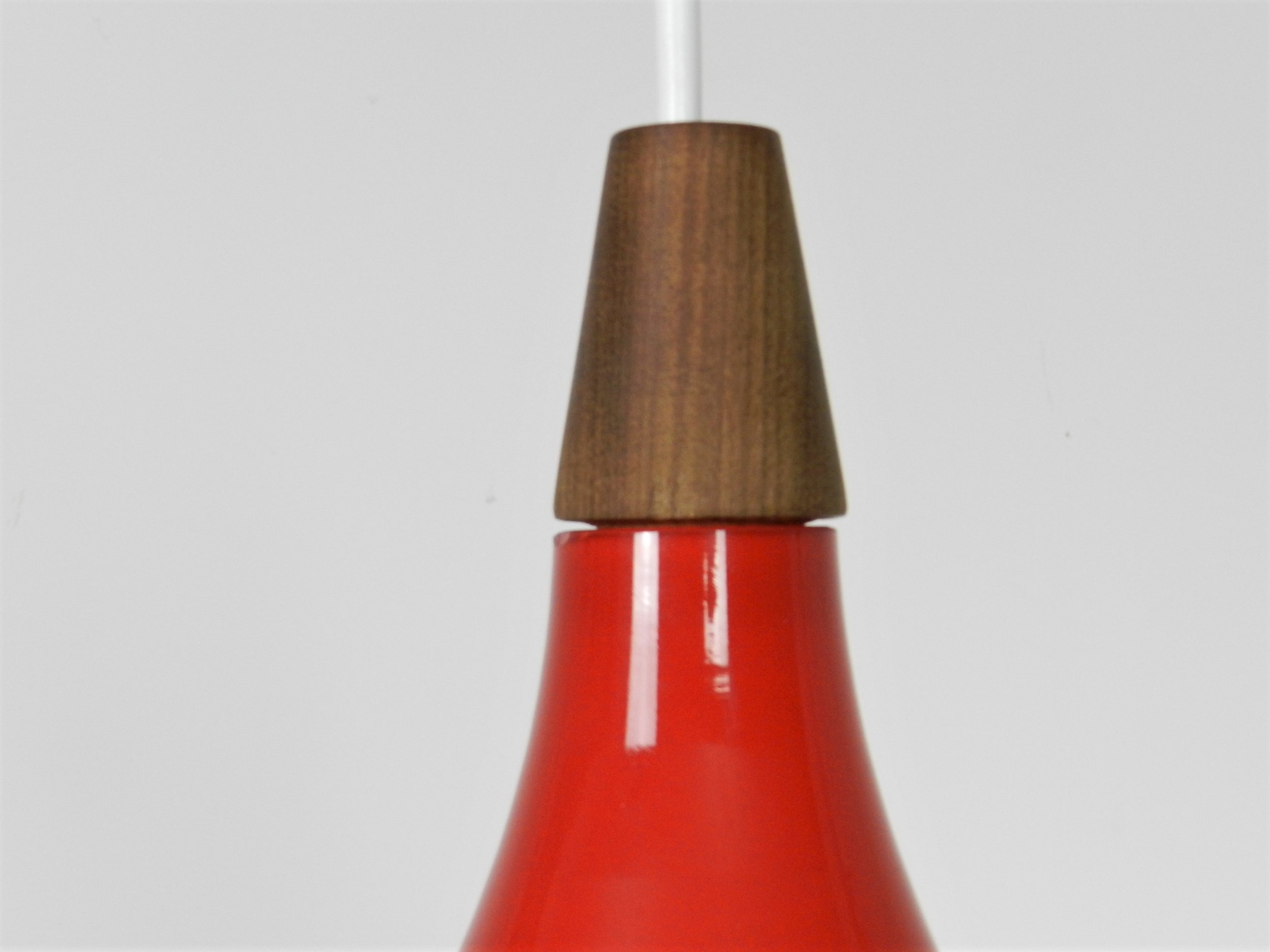 Red cased glass pendant lamp with teak finial by Holmegaard.  Denmark, 1960s.