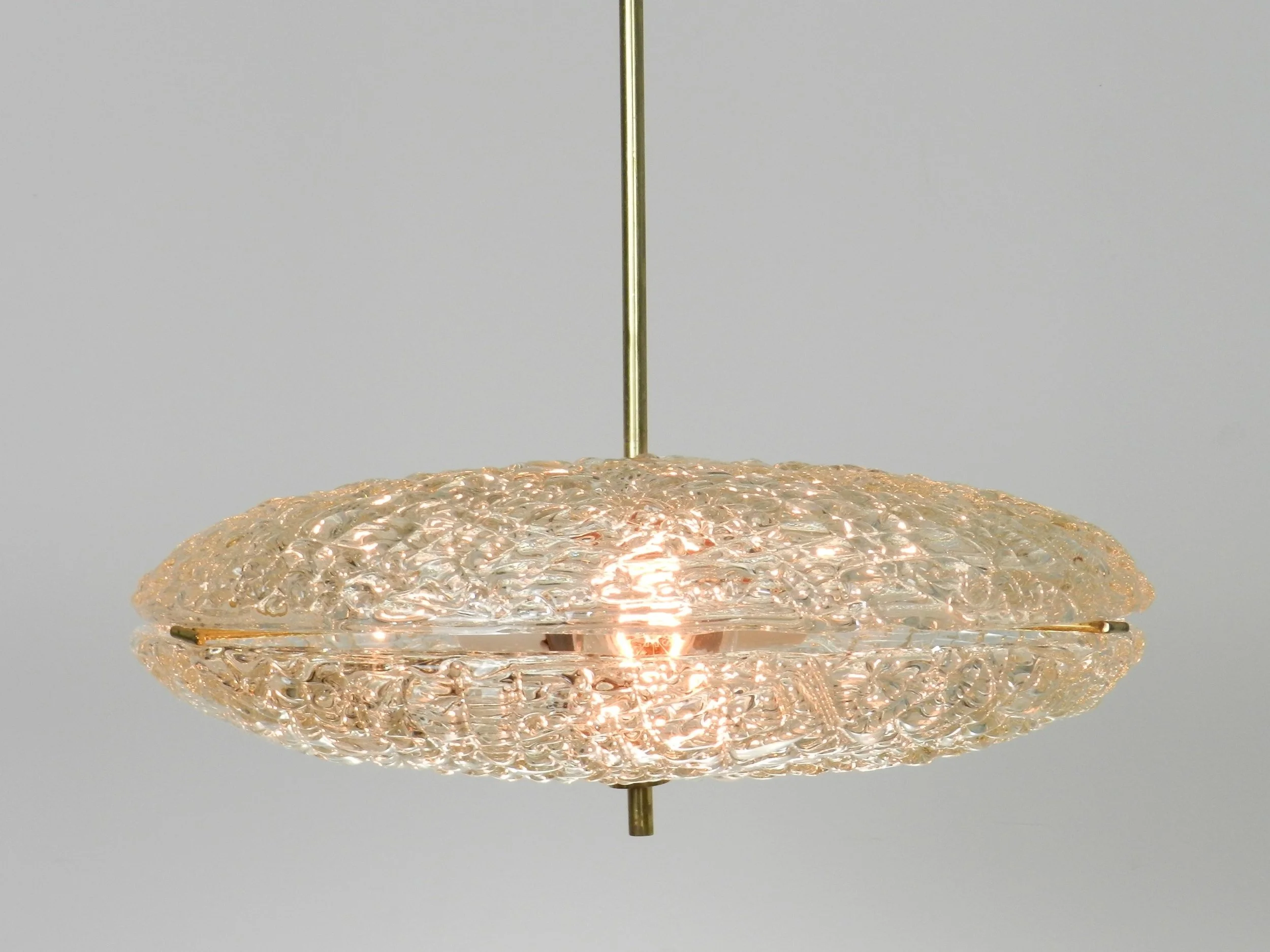 Crystal chandelier with brass hardware designed by Carl Fagerlund for Orrefors.  Sweden, 1950s.