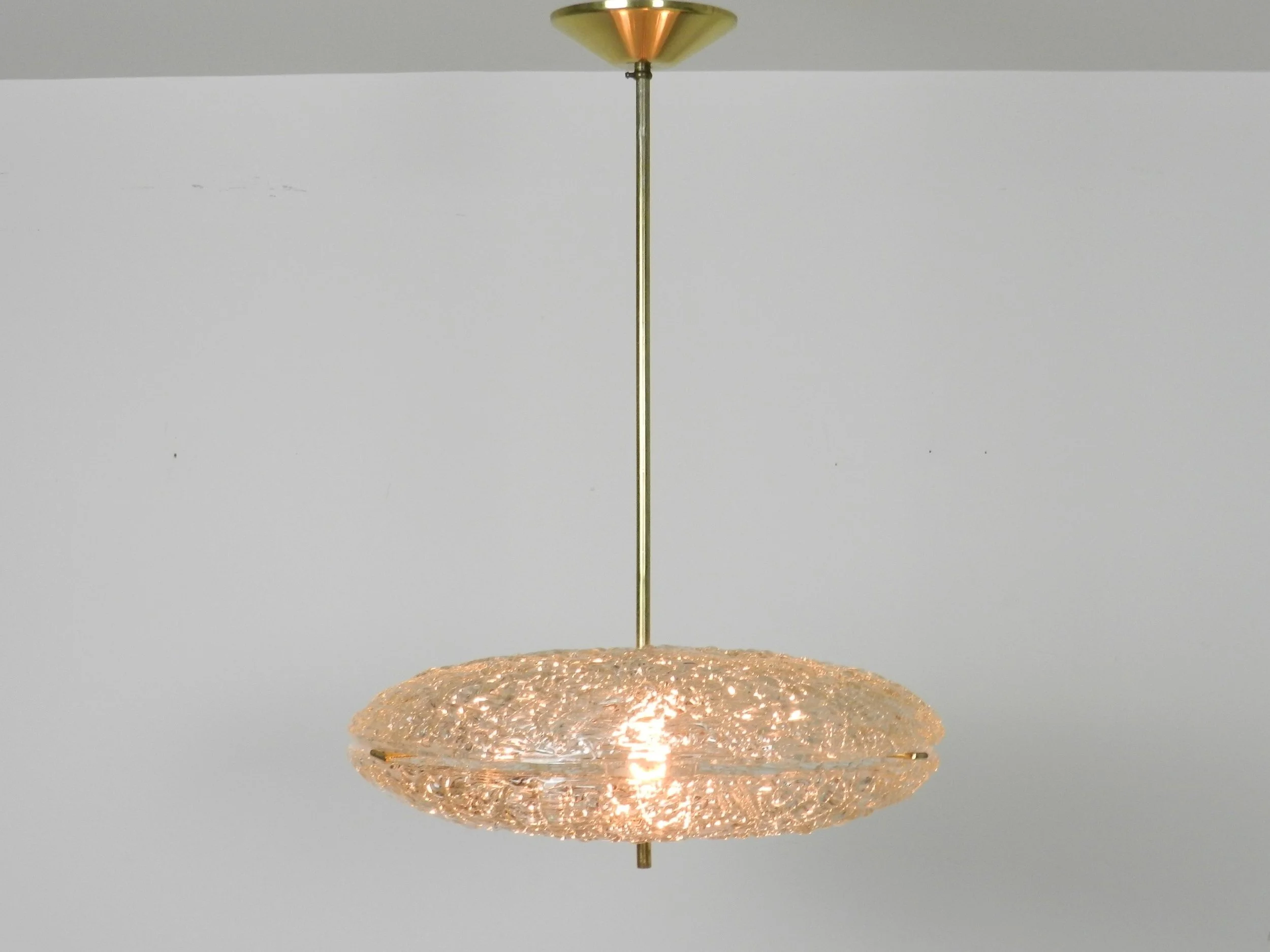 Crystal chandelier with brass hardware designed by Carl Fagerlund for Orrefors.  Sweden, 1950s.