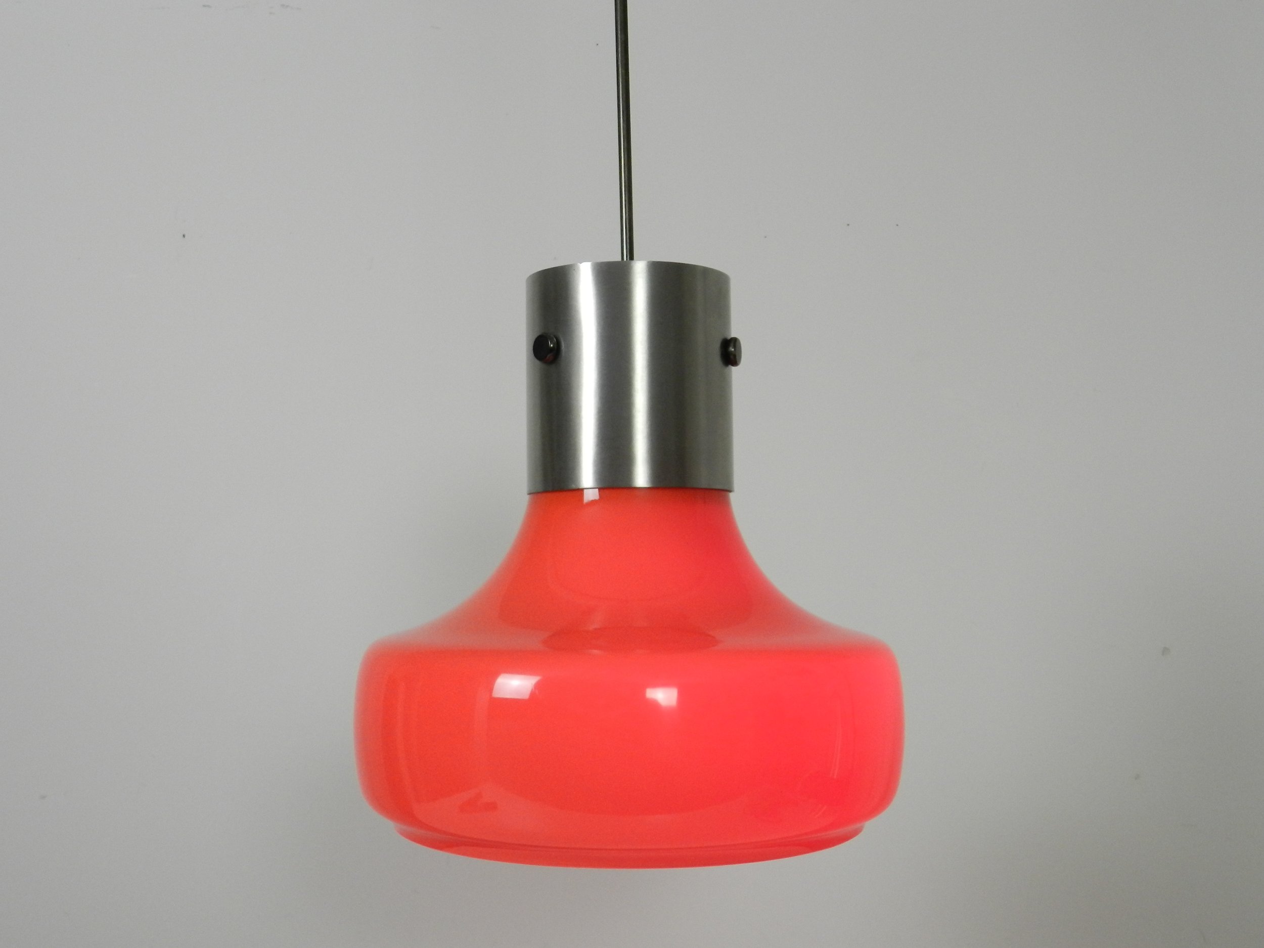 Space age pendant lamp in orange case glass with inner white glass shade and steel hardware.  Italy, 1970s.