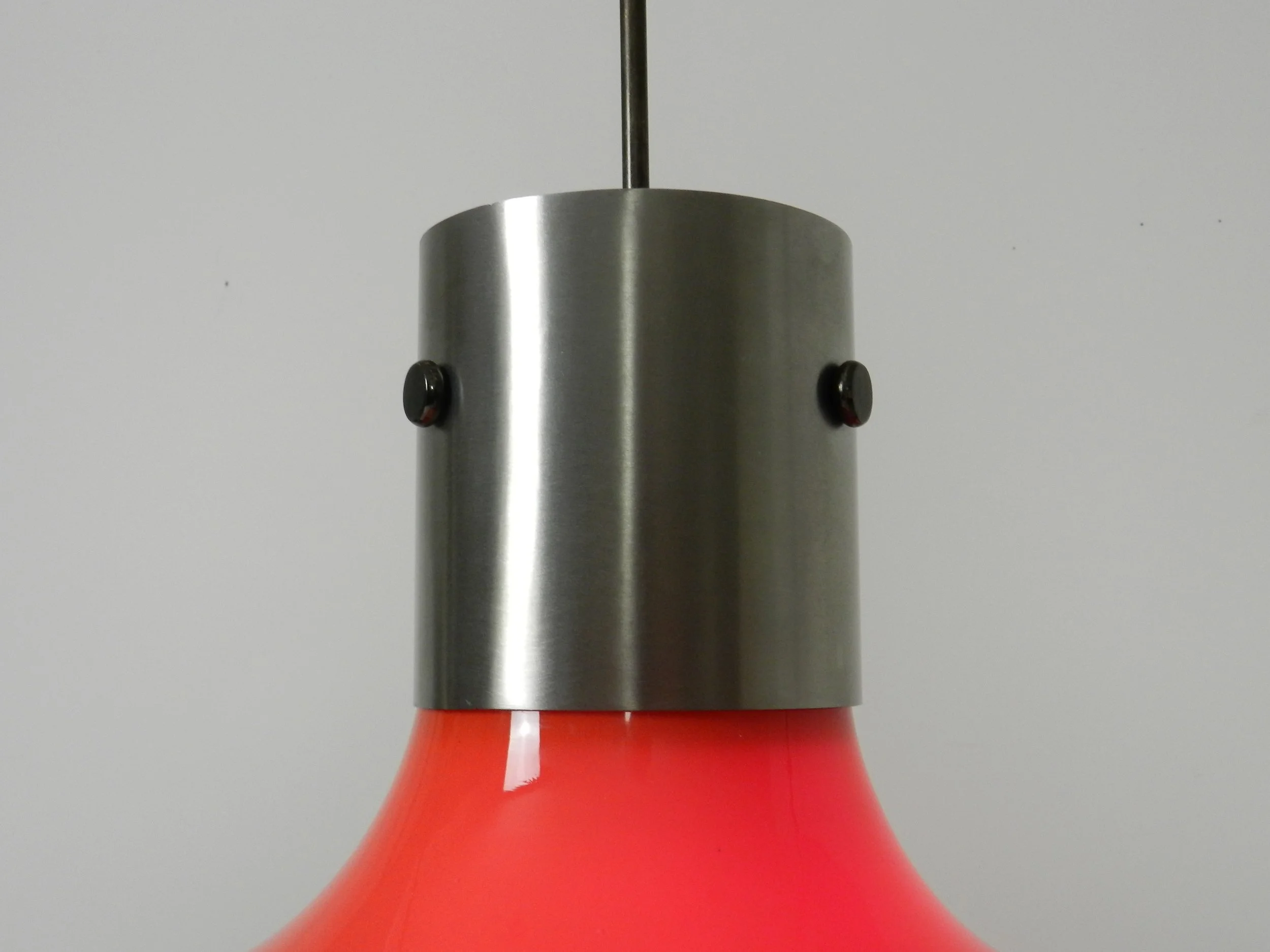 Space age pendant lamp in orange case glass with inner white glass shade and steel hardware.  Italy, 1970s.