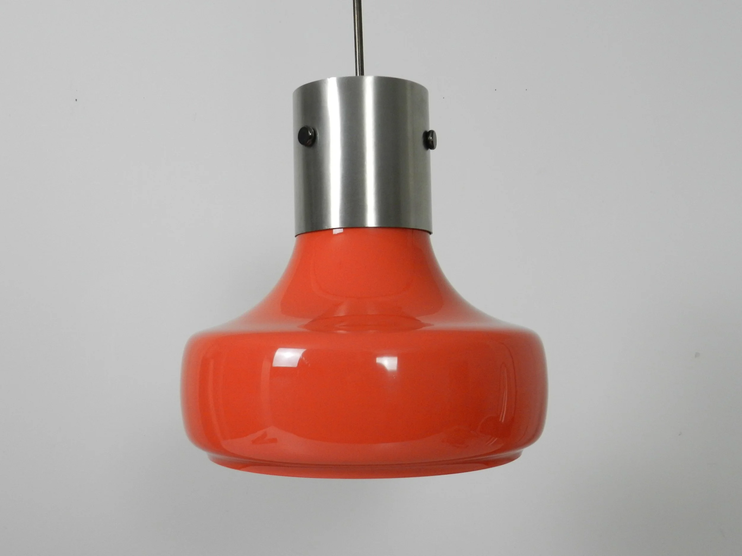 Space age pendant lamp in orange case glass with inner white glass shade and steel hardware.  Italy, 1970s.