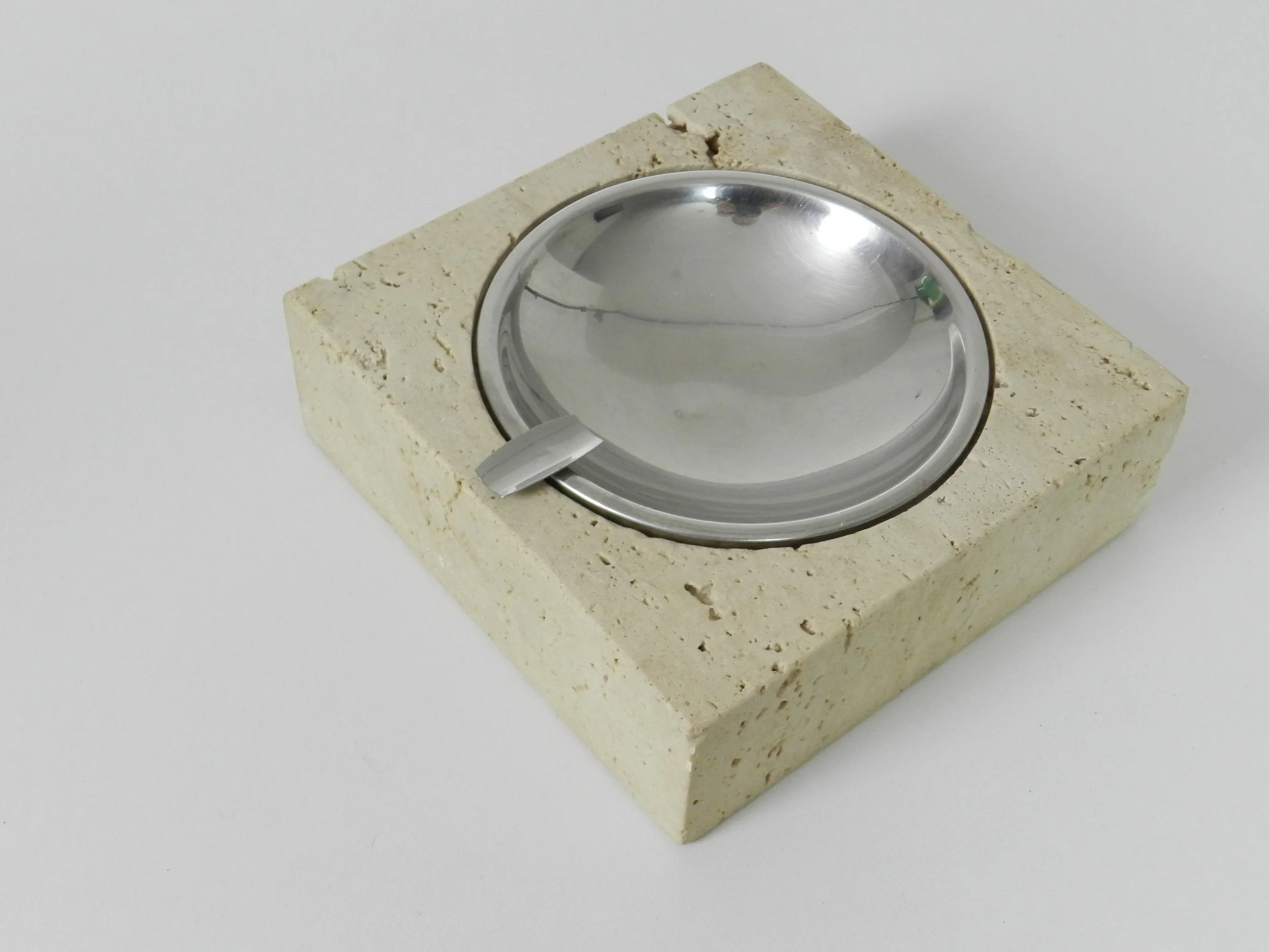 Travertine and stainless steel ashtray designed by Fratelli Mannelli for Raymor.  Italy, 1960s.