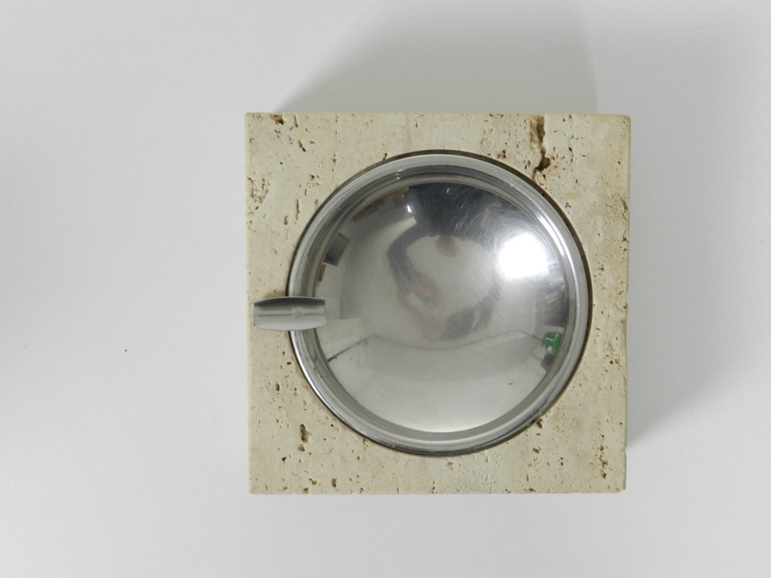 Travertine and stainless steel ashtray designed by Fratelli Mannelli for Raymor.  Italy, 1960s.