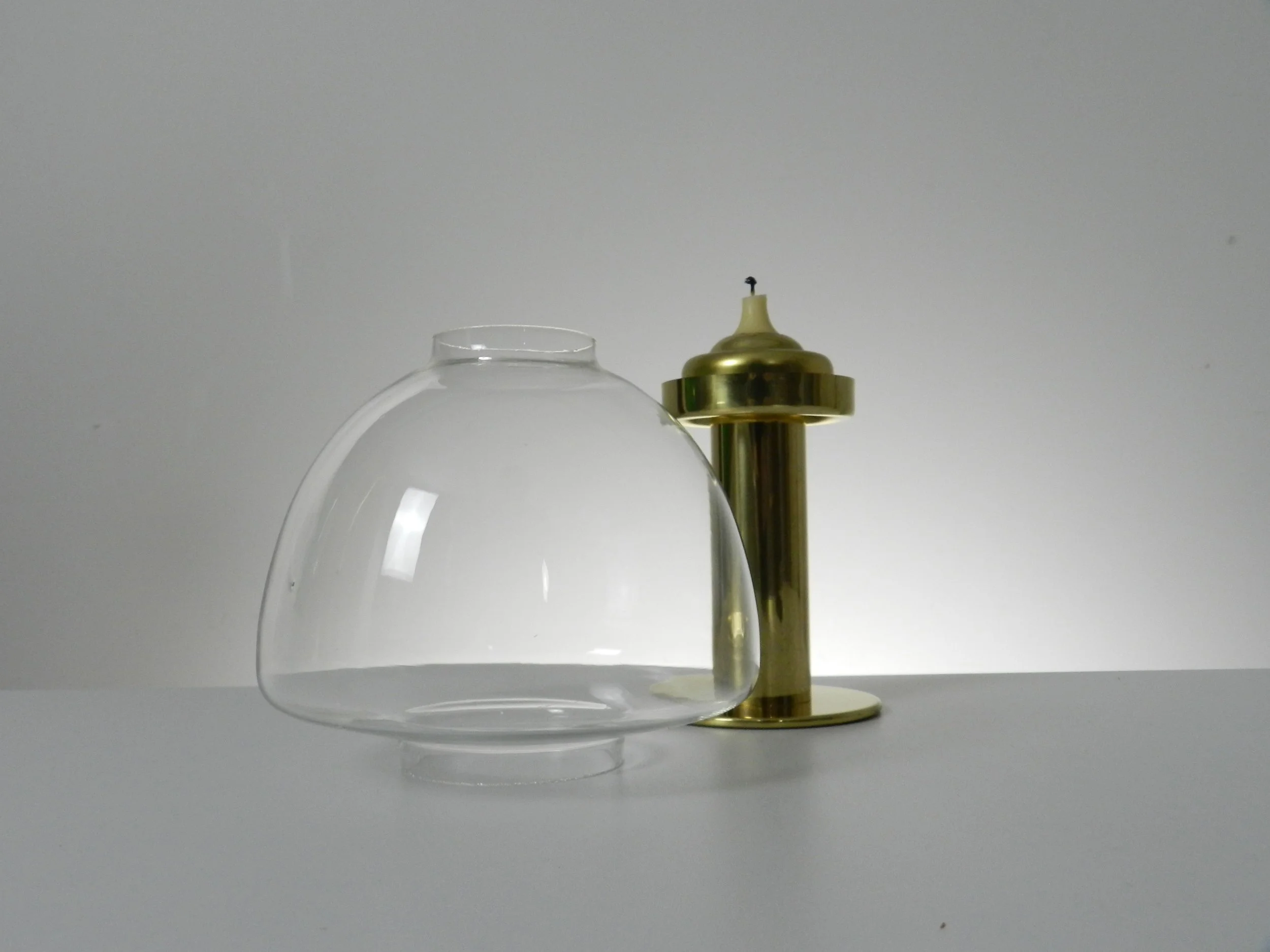 Brass spring loaded candle holder with glass shade. Designed by Hans-Agne Jakobsson.  Sweden, 1960s.