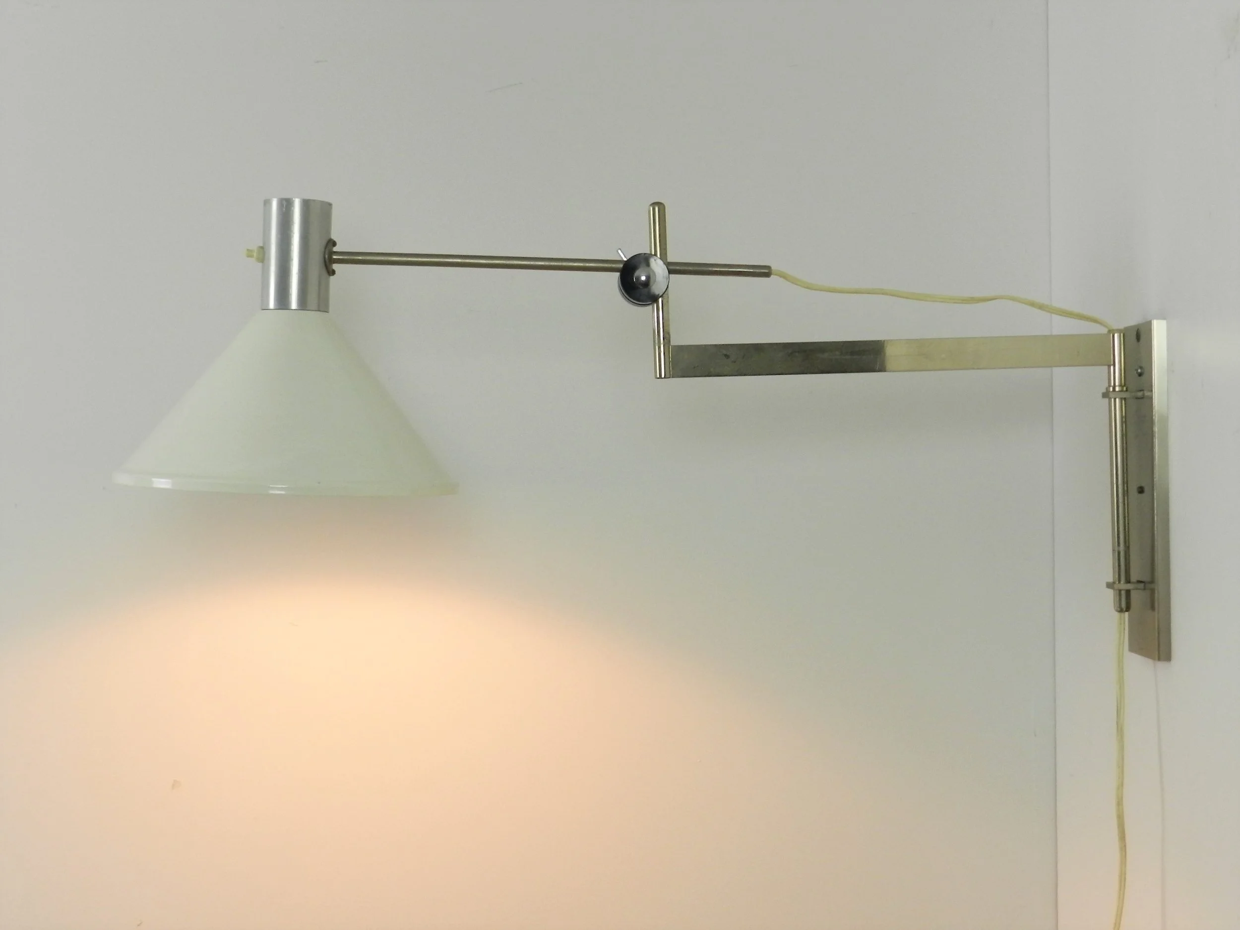 Articulating wall lamp in chrome with enameled metal shade.  Netherlands, 1960s.