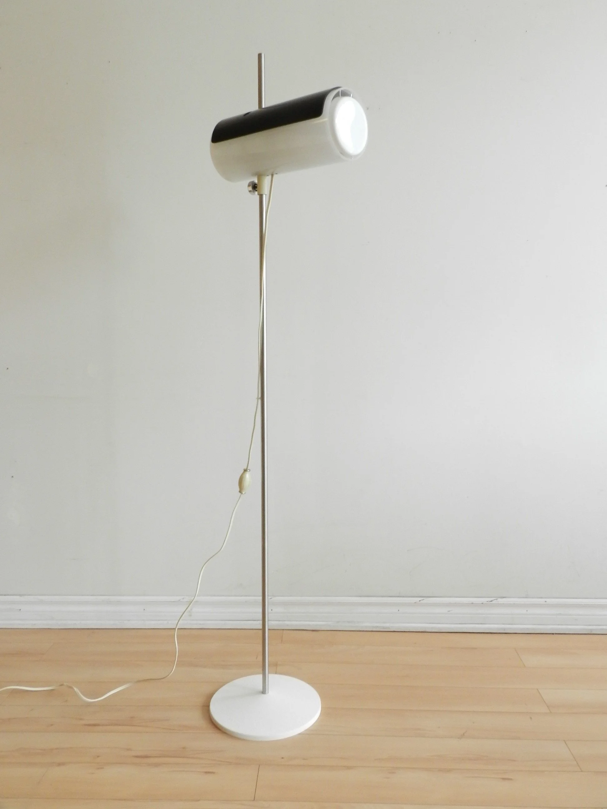 Rare floor lamp attributed to Douglas Ball and John Berezowsky. Steel base and acrylic shade with adjustable viser.  Canada, 1960s.