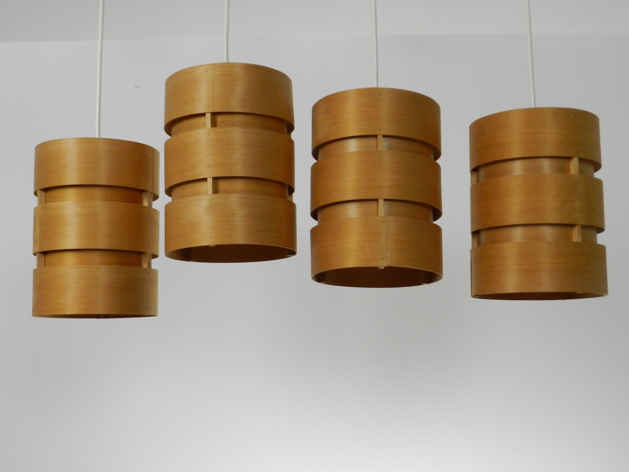 Set of four pendant lamps in pine veneer. Designed by Hans-Agne Jakobsson for AB Ellysett.  Sweden, 1960s.