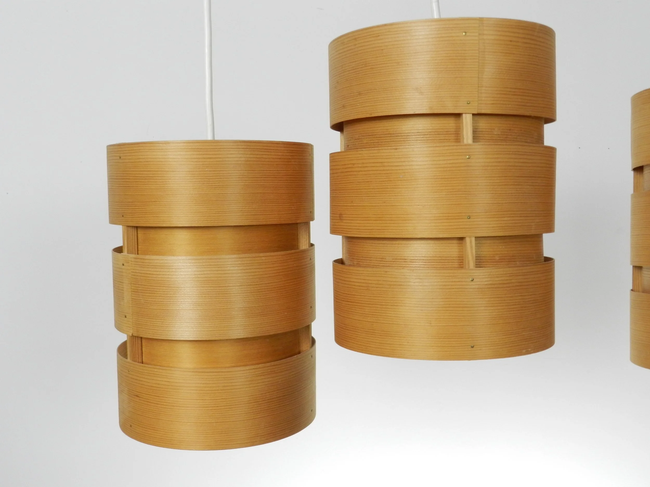 Set of four pendant lamps in pine veneer. Designed by Hans-Agne Jakobsson for AB Ellysett.  Sweden, 1960s.
