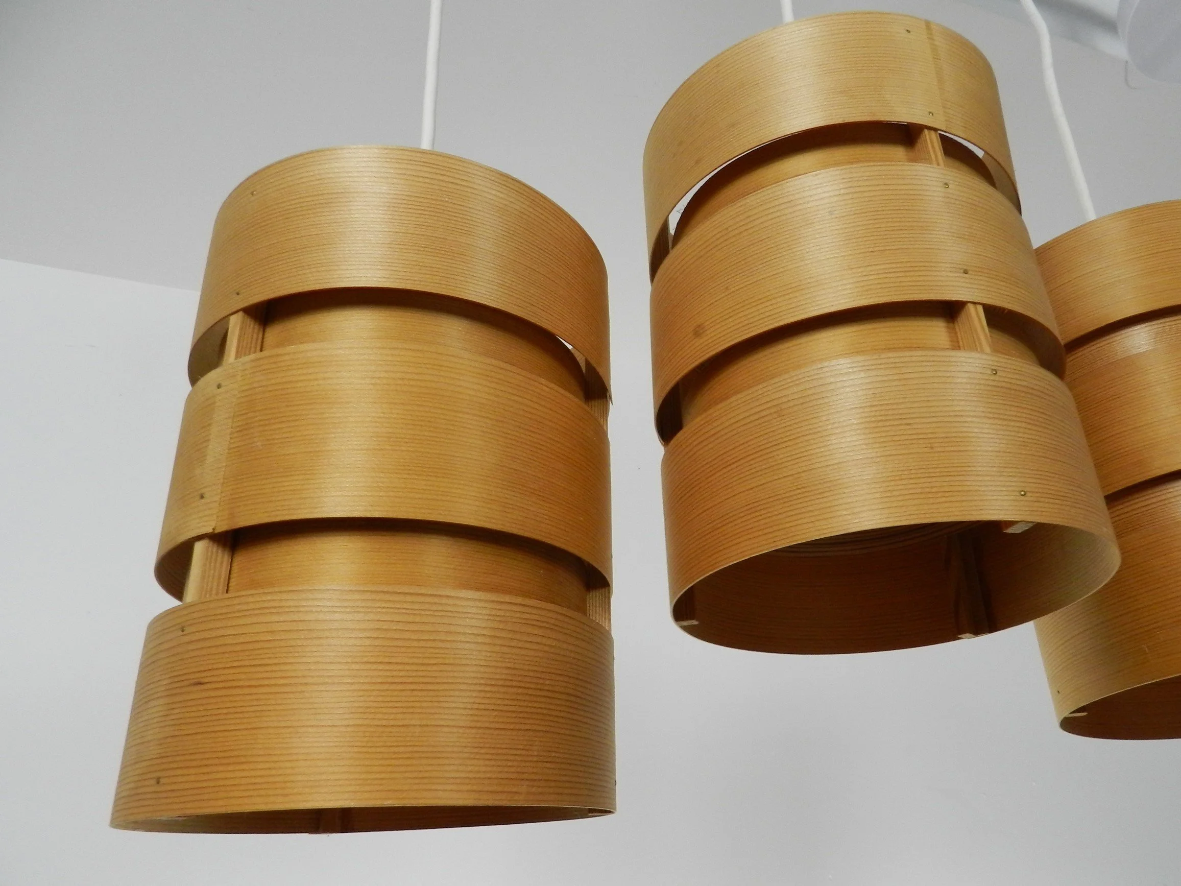 Set of four pendant lamps in pine veneer. Designed by Hans-Agne Jakobsson for AB Ellysett.  Sweden, 1960s.