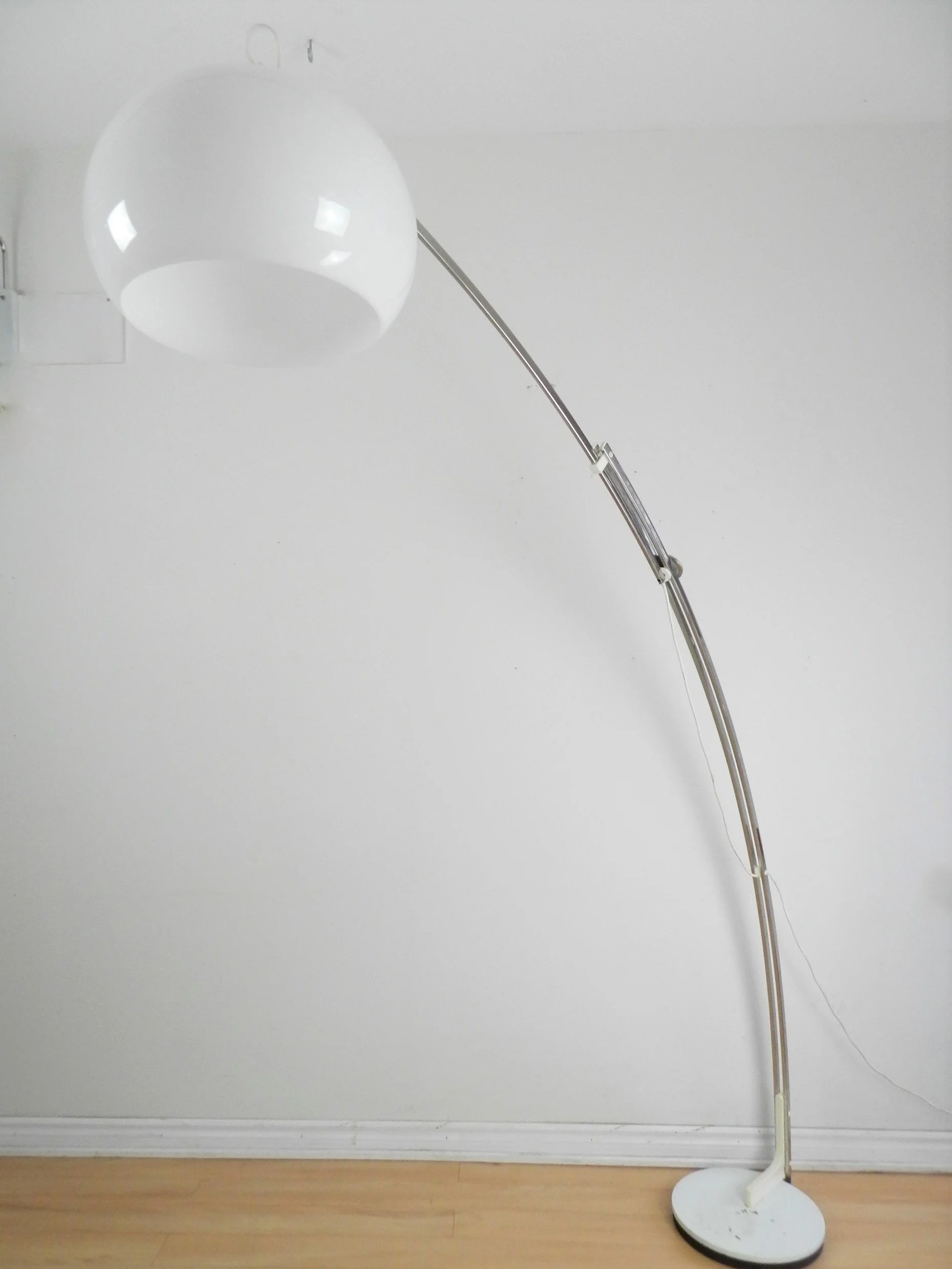 Adjustable arc lamp in chrome with acrylic shade by Reggiani.  Italy, 1970s.